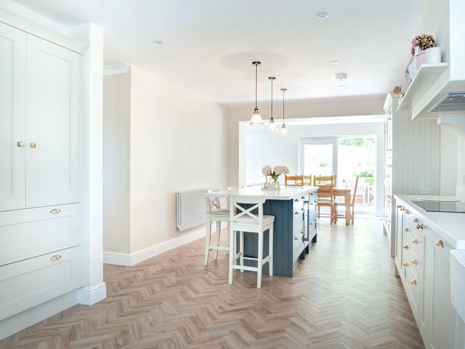 A large downstairs kitchen conversion of a detached house bringing together a kitchen and dining room and creating a utility and cloakroom in Steyning, West Sussex.