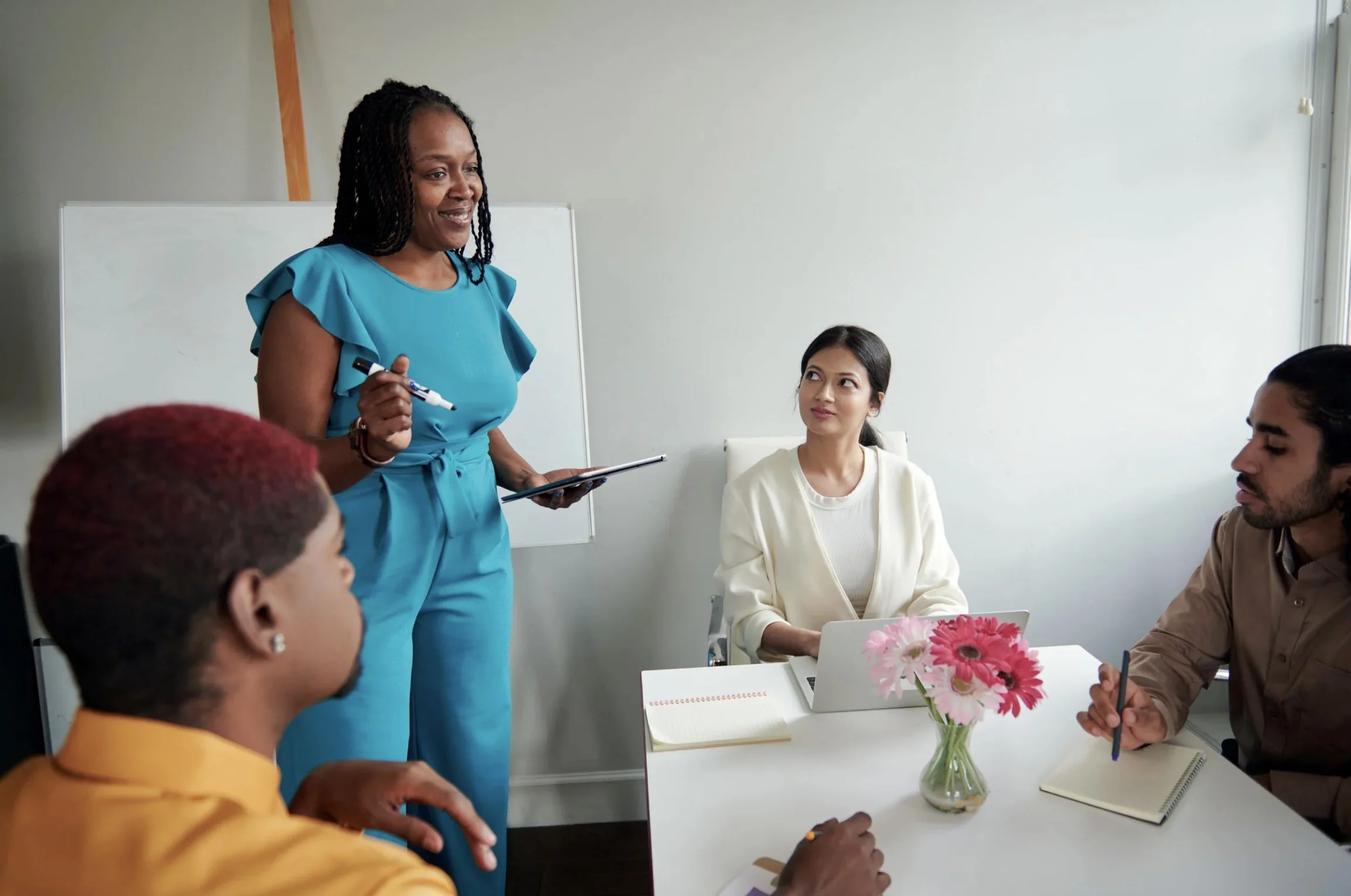A coach facilitating a team of people towards their best actions