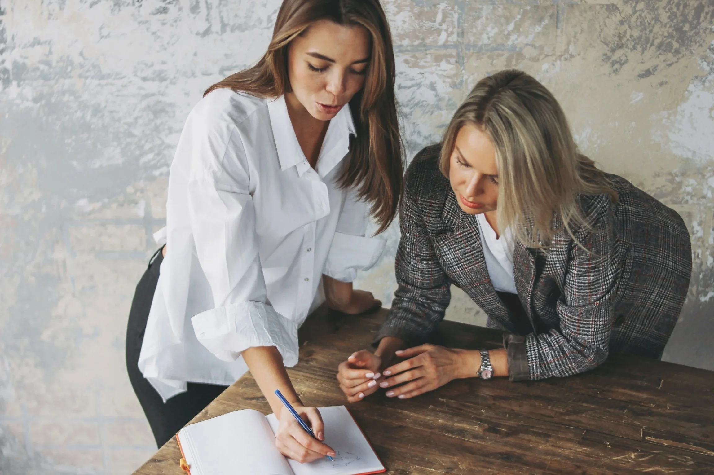 An image of two coaches collaborating together