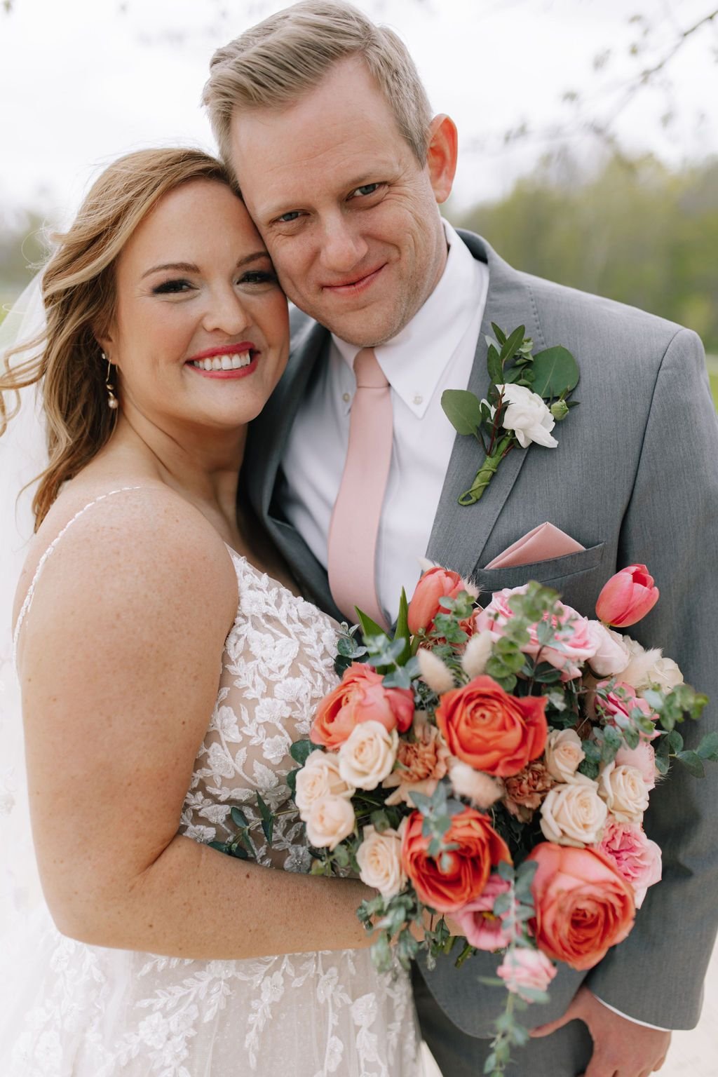 Kristi and tom indianapolis wedding couple photo bridal bouquet warm pinnk florals.jpg