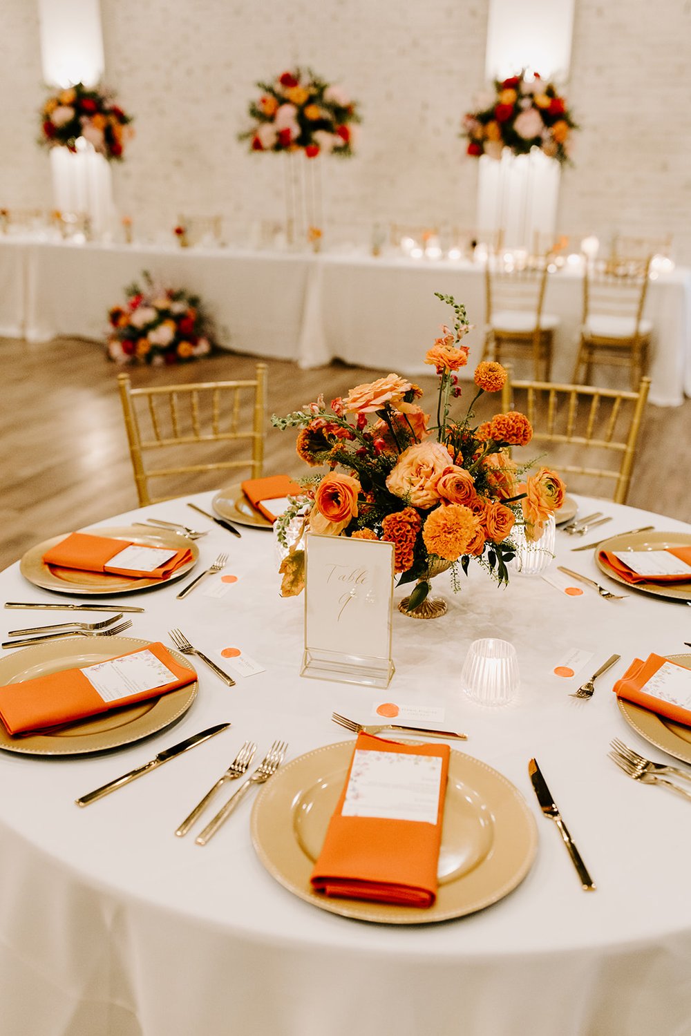 wedding reception warm orange floral centerpieces.jpg