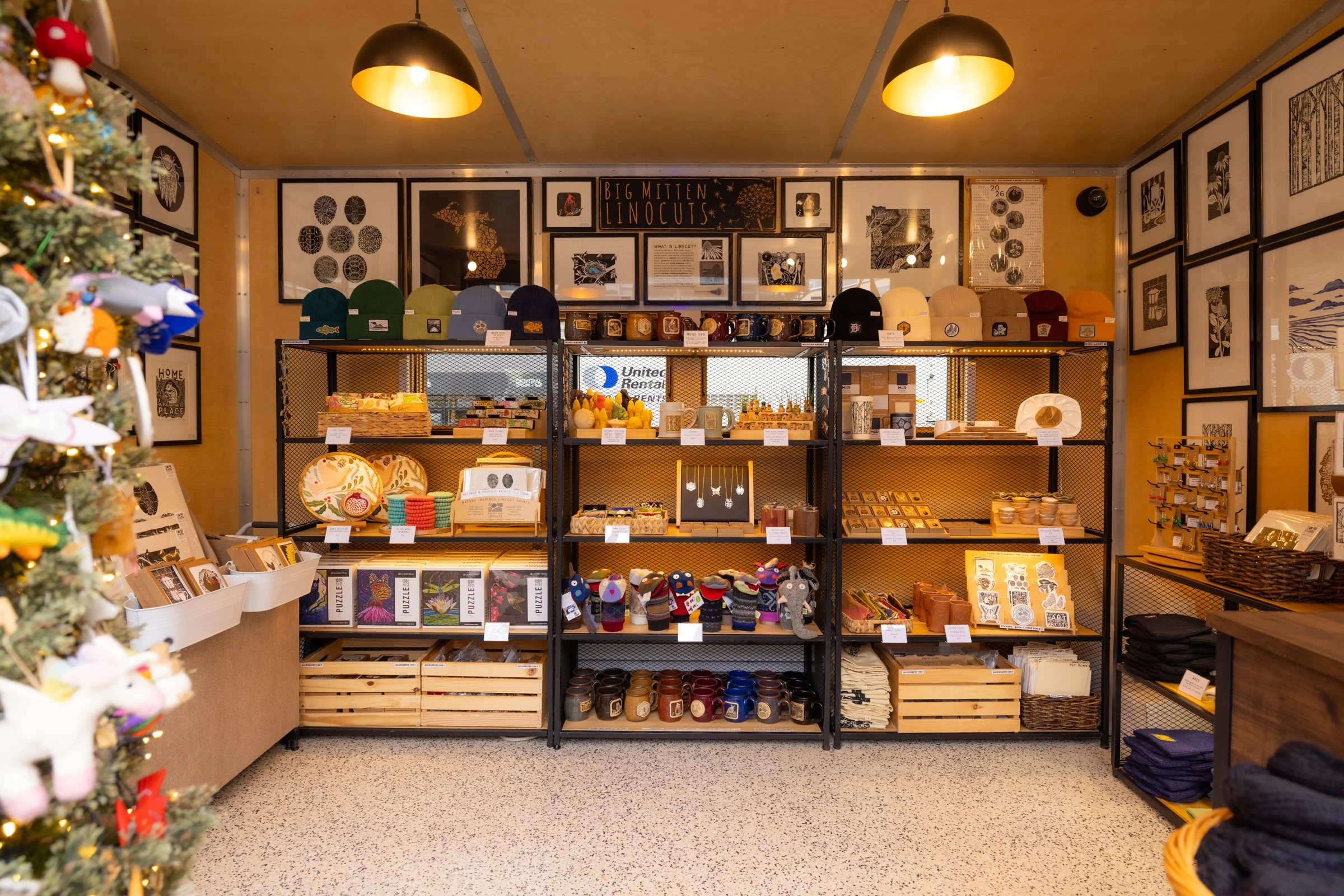 Interior photo of Big Mitten Linocuts market stall at the Holiday Markets in Cadillac Square, downtown Detroit.