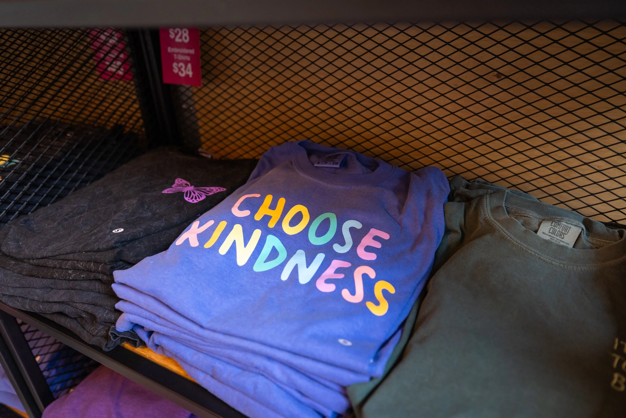Product photo from the InkCourage market stall at the Holiday Markets in Cadillac Square, downtown Detroit. Featuring a shirt which says, "Choose Kindness."
