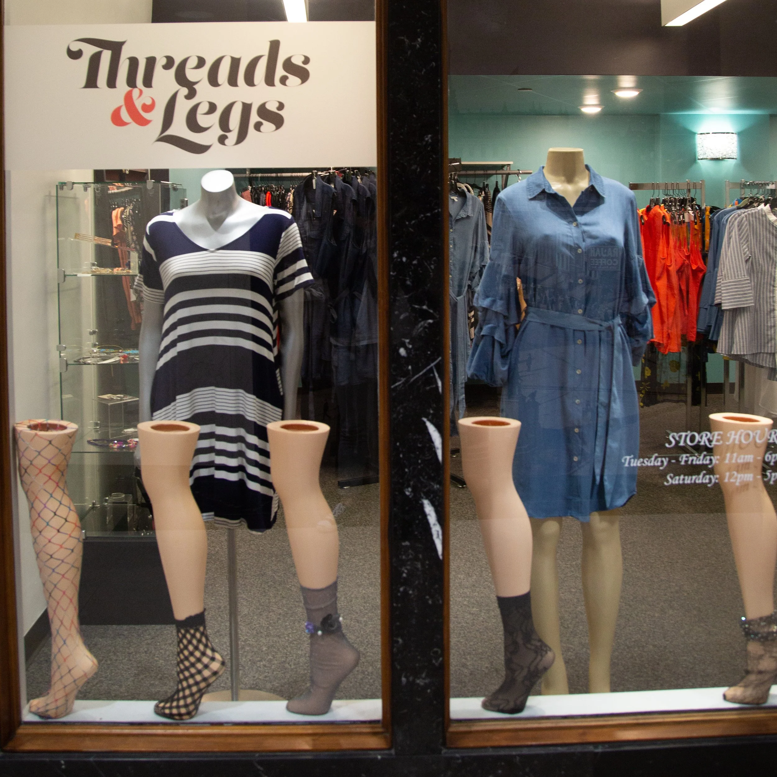 Candles at Threads & Legs featuring definitions printed on the glass.