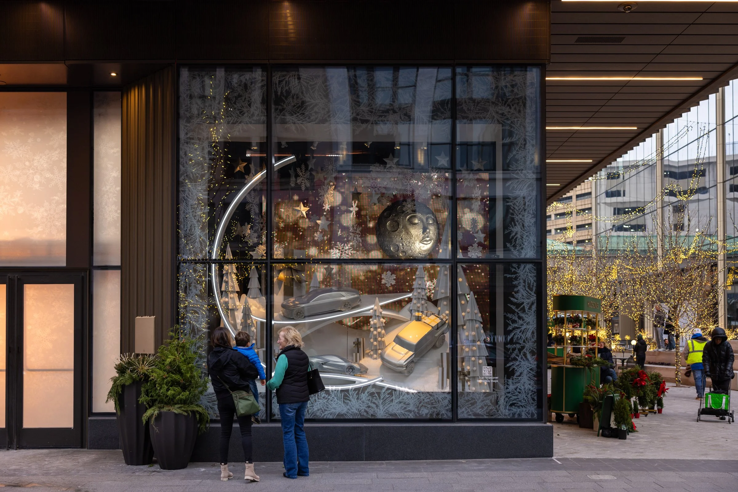 Onlookers of a winter-themed window display at Entrance One in Hudson's Detroit.
