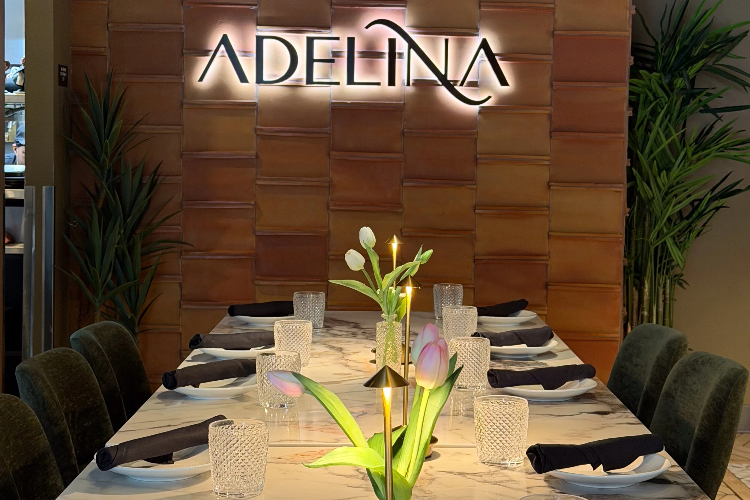 Interior photo of Adelina restaurant in Detroit showing a set dining table.