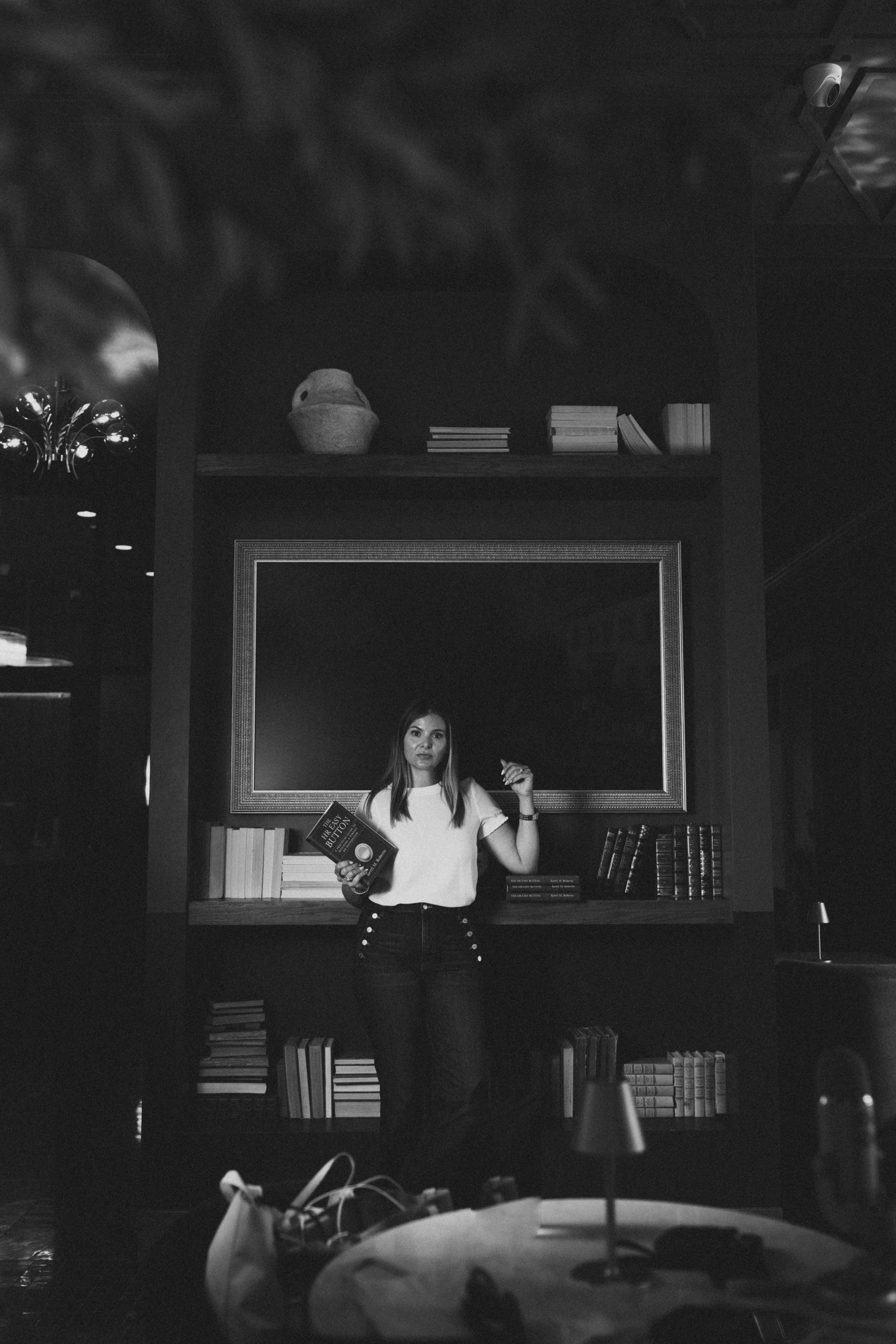 Black and white portrait of Kerri M. Roberts, Missouri HR consultant and leadership advisor, confidently holding the HR Easy Button.