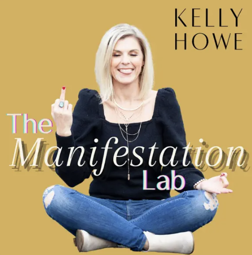 Kelly Howe sitting cross-legged in a black top and ripped jeans, smiling and gesturing with her middle finger raised, with the text 'The Manifestation Lab' and her name on a yellow background.