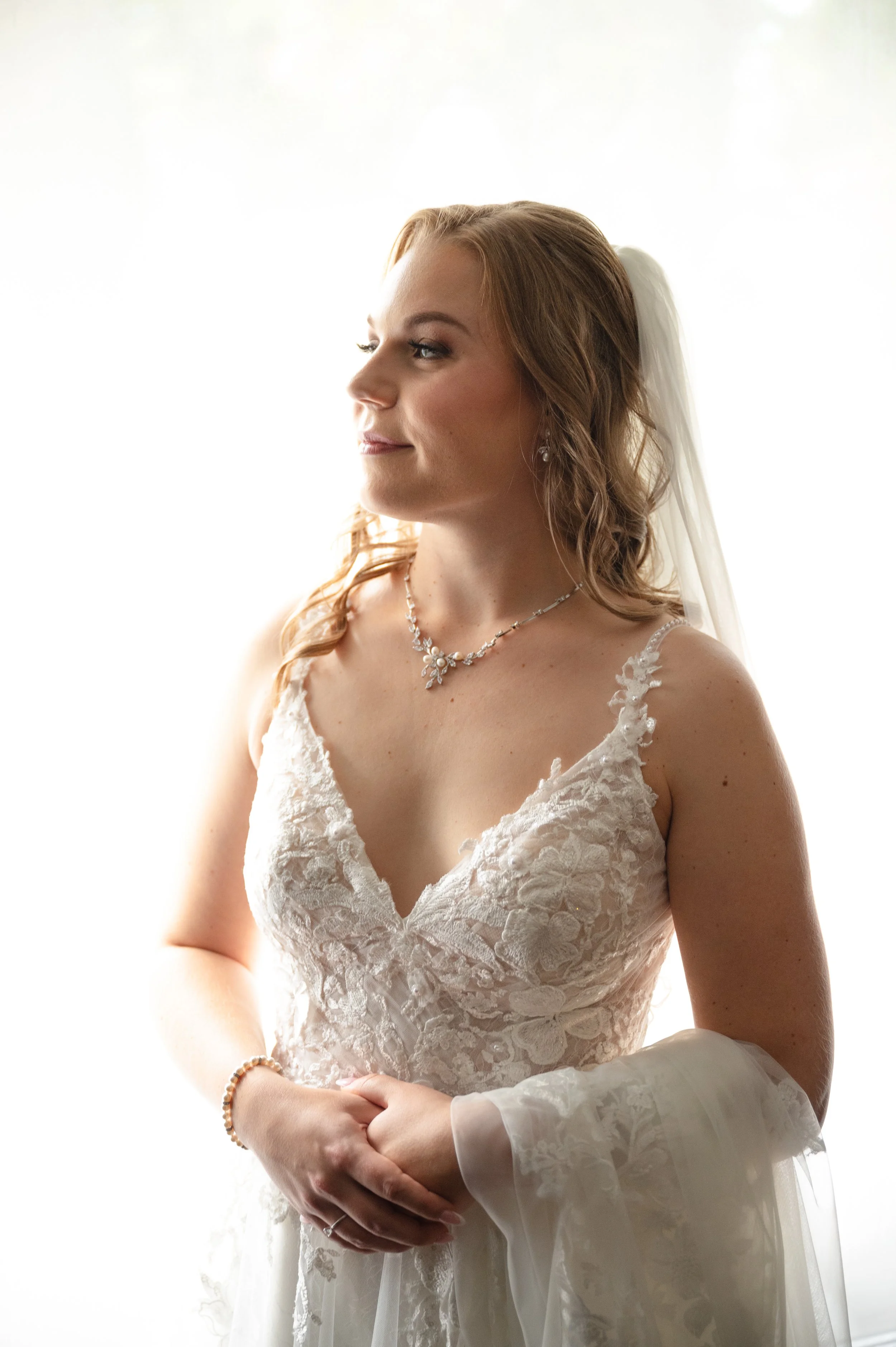 Bride smiling in soft natural light during her getting-ready portraits at her home in Mississauga.