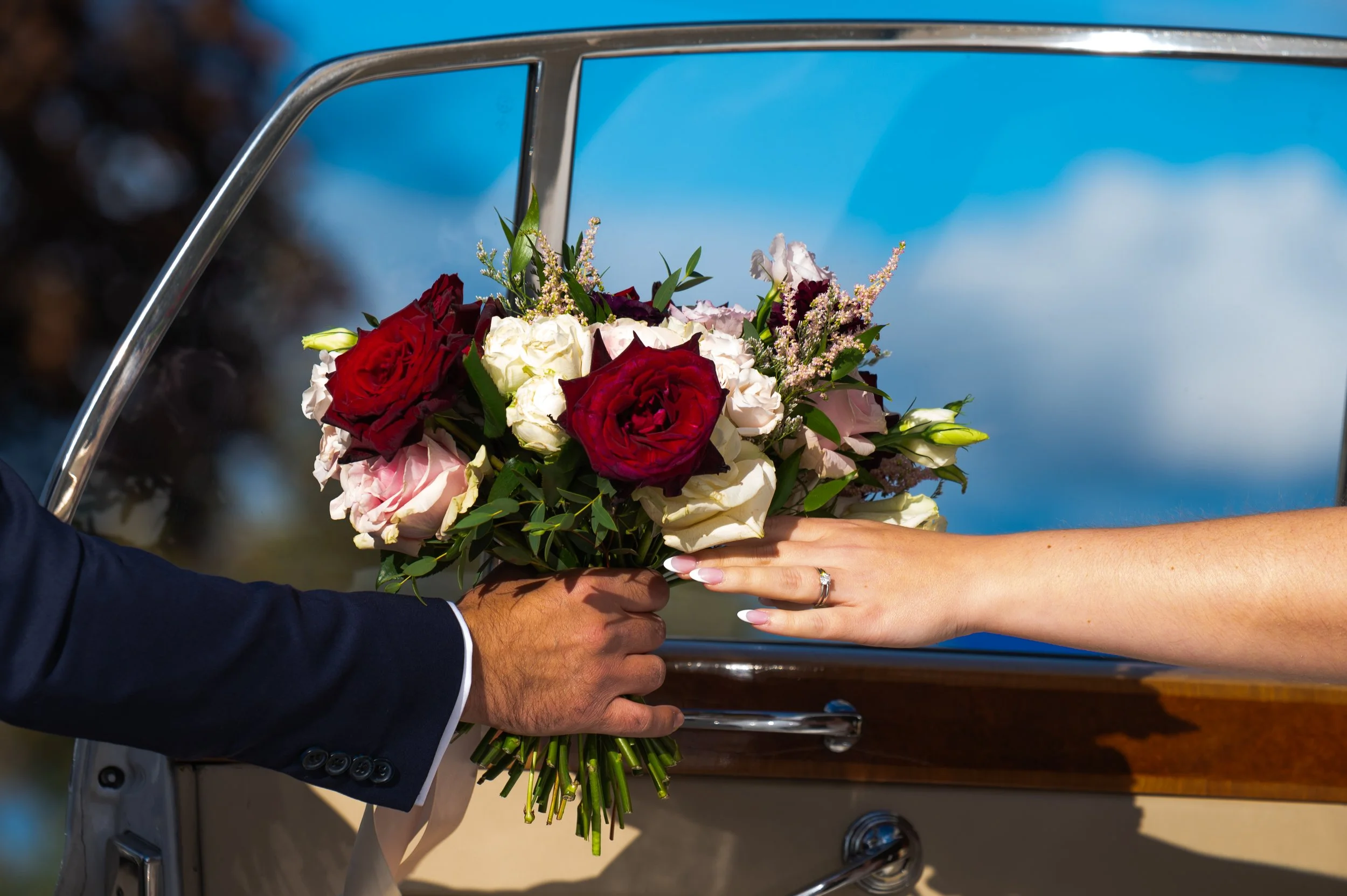 Close-up of a wedding bouquet being handed over during portraits at Roma’s Event Space in Mississauga.