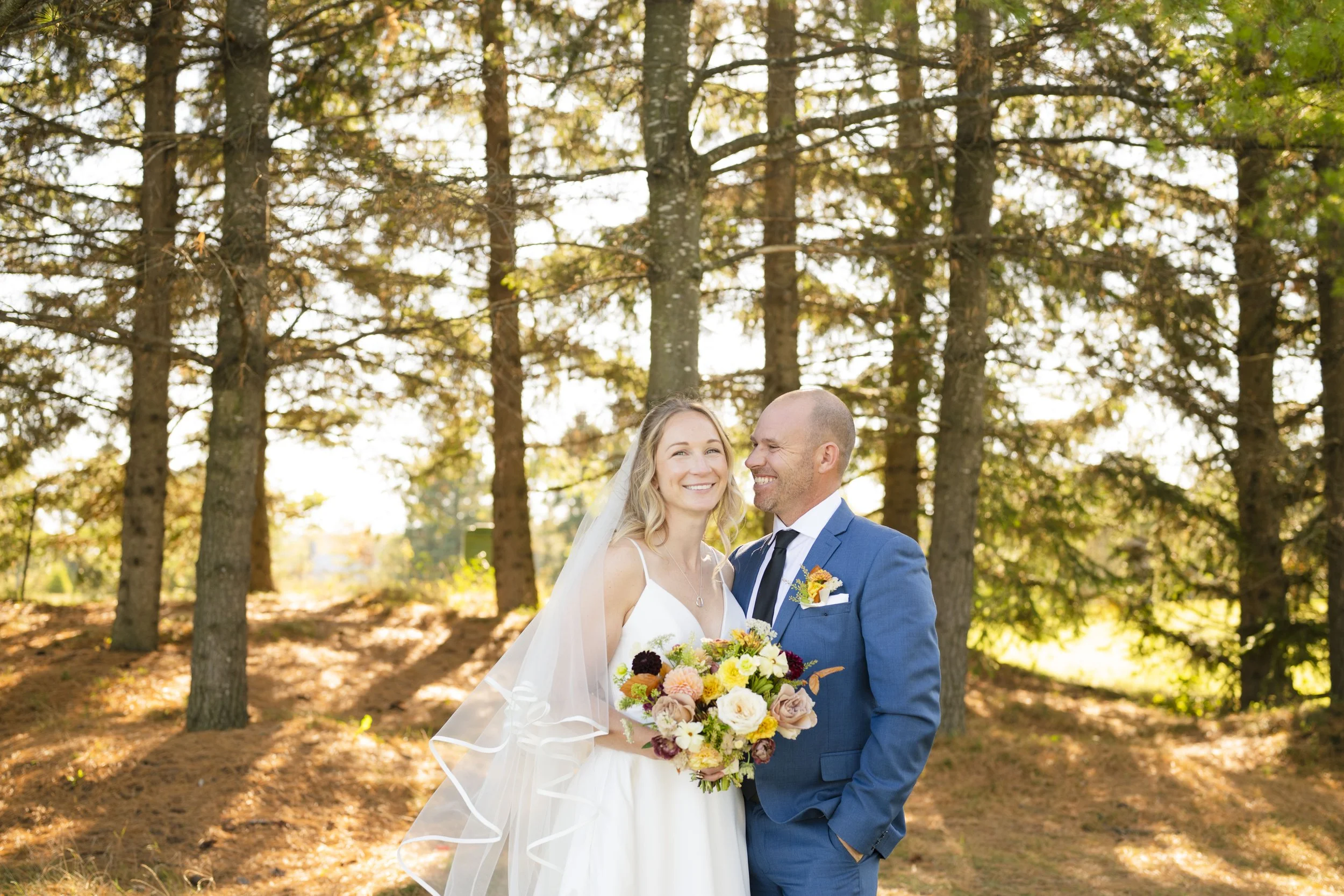 Bride and Groom smiling during sunny day at TPC Toronto Osprey Valley