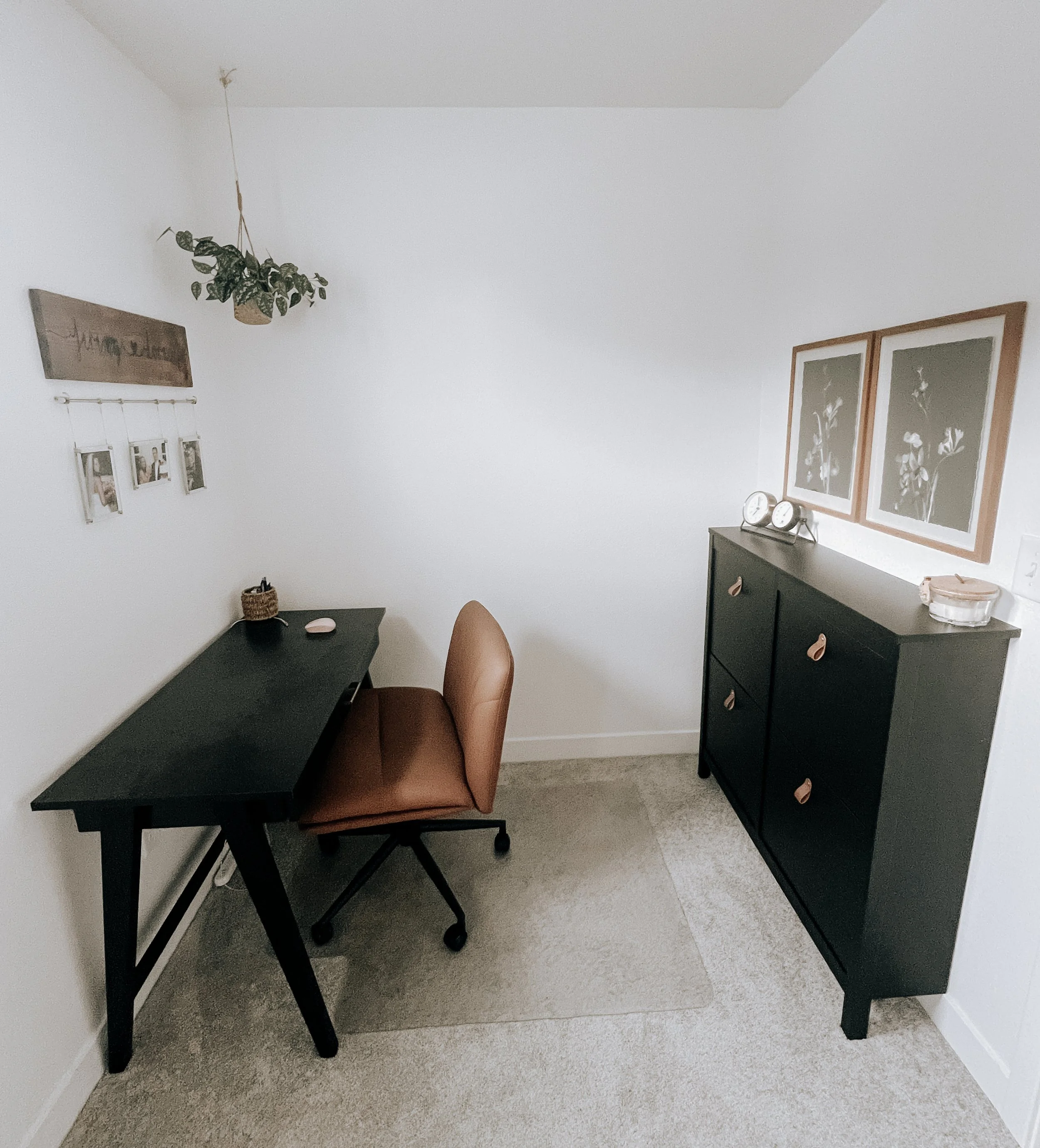 Modern Raymore home office design with black desk, tan chair, and greenery accents.