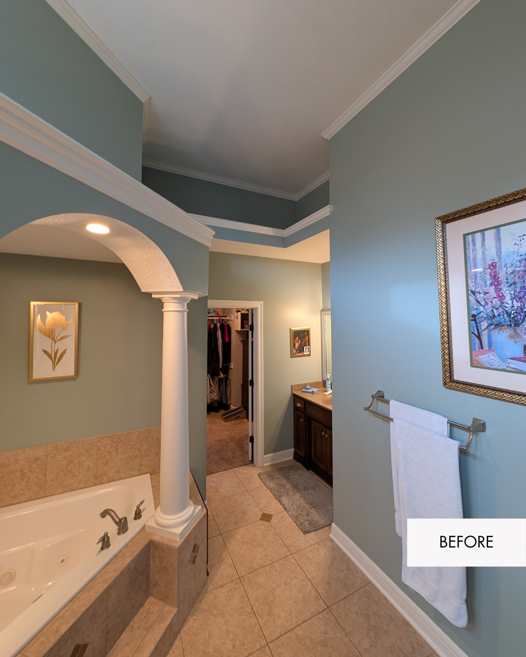 Before photo showing divided primary bathroom layout with columns, tub surround and separate spaces
