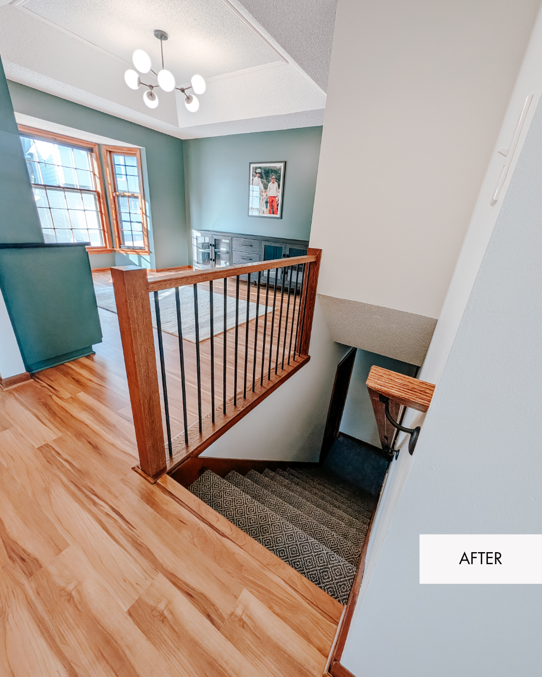 Newly remodeled entryway with new railing, fresh stair carpet, fresh paint, new light fixture and Luxury vinyl plank flooring