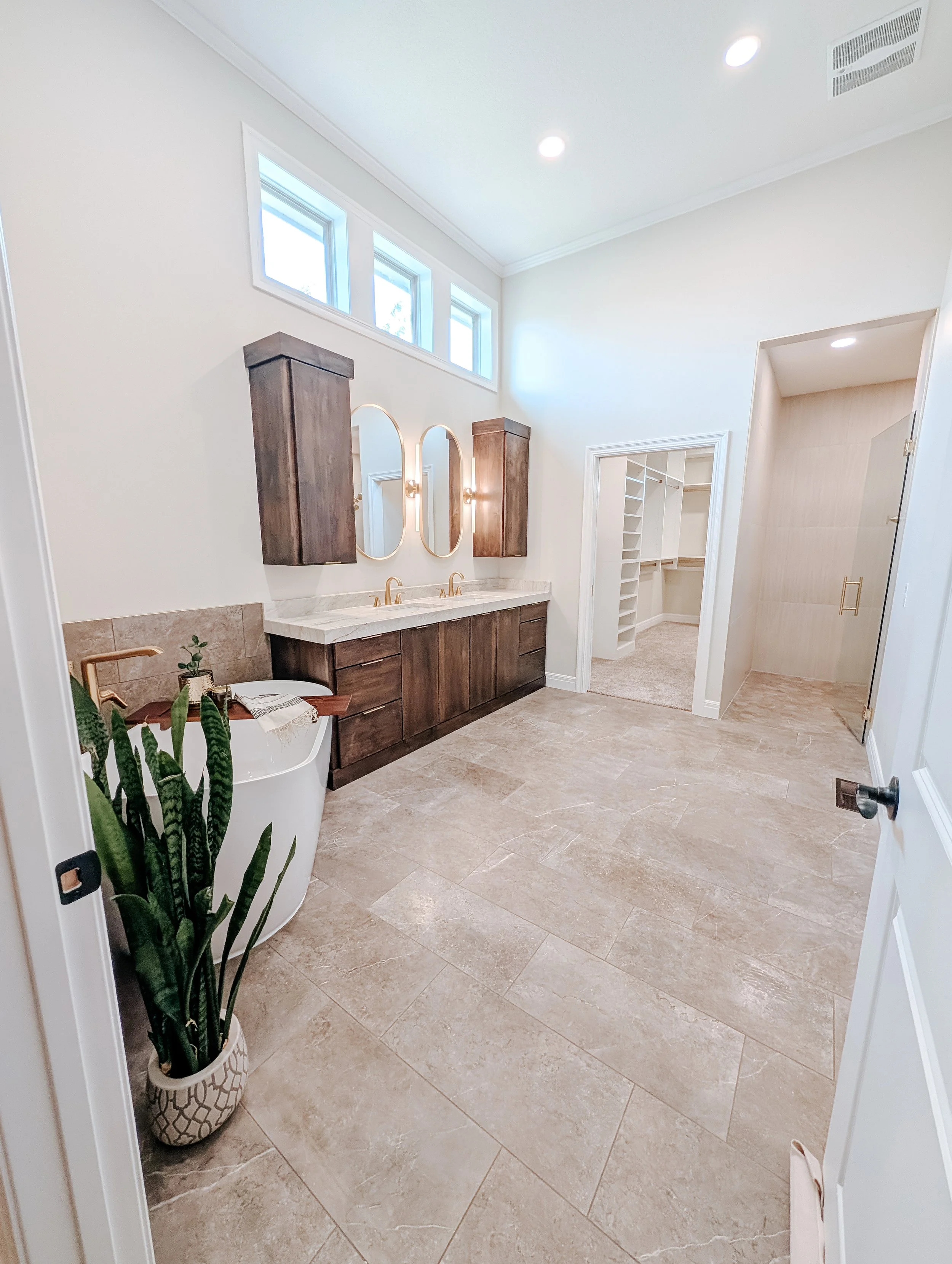Lee's Summit bathroom remodel with freestanding tub, double vanity, expanded closet, walk in shower and heated tile floors