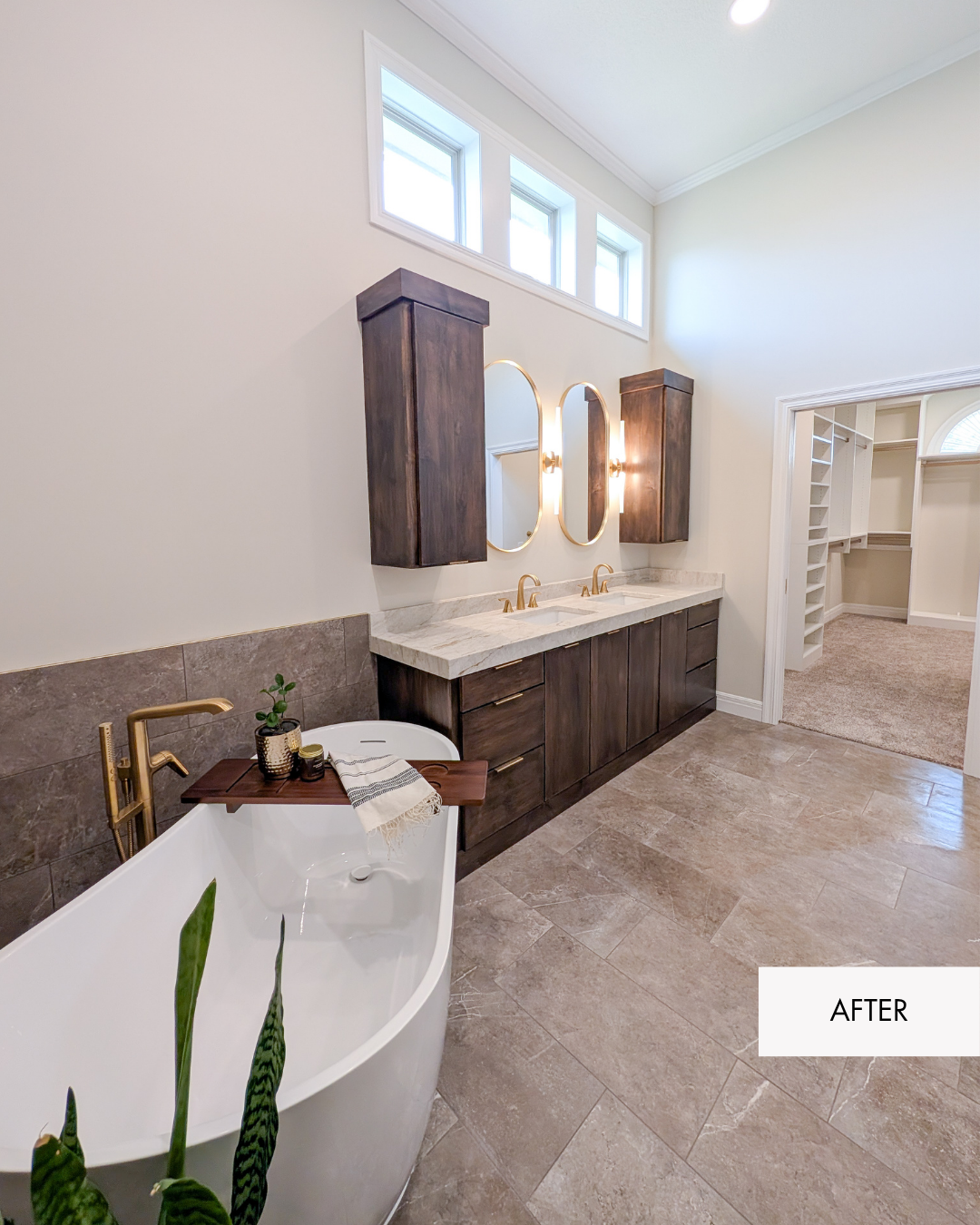 Open remodeled primary bathroom with soaking tub, custom double vanity, and expanded closet