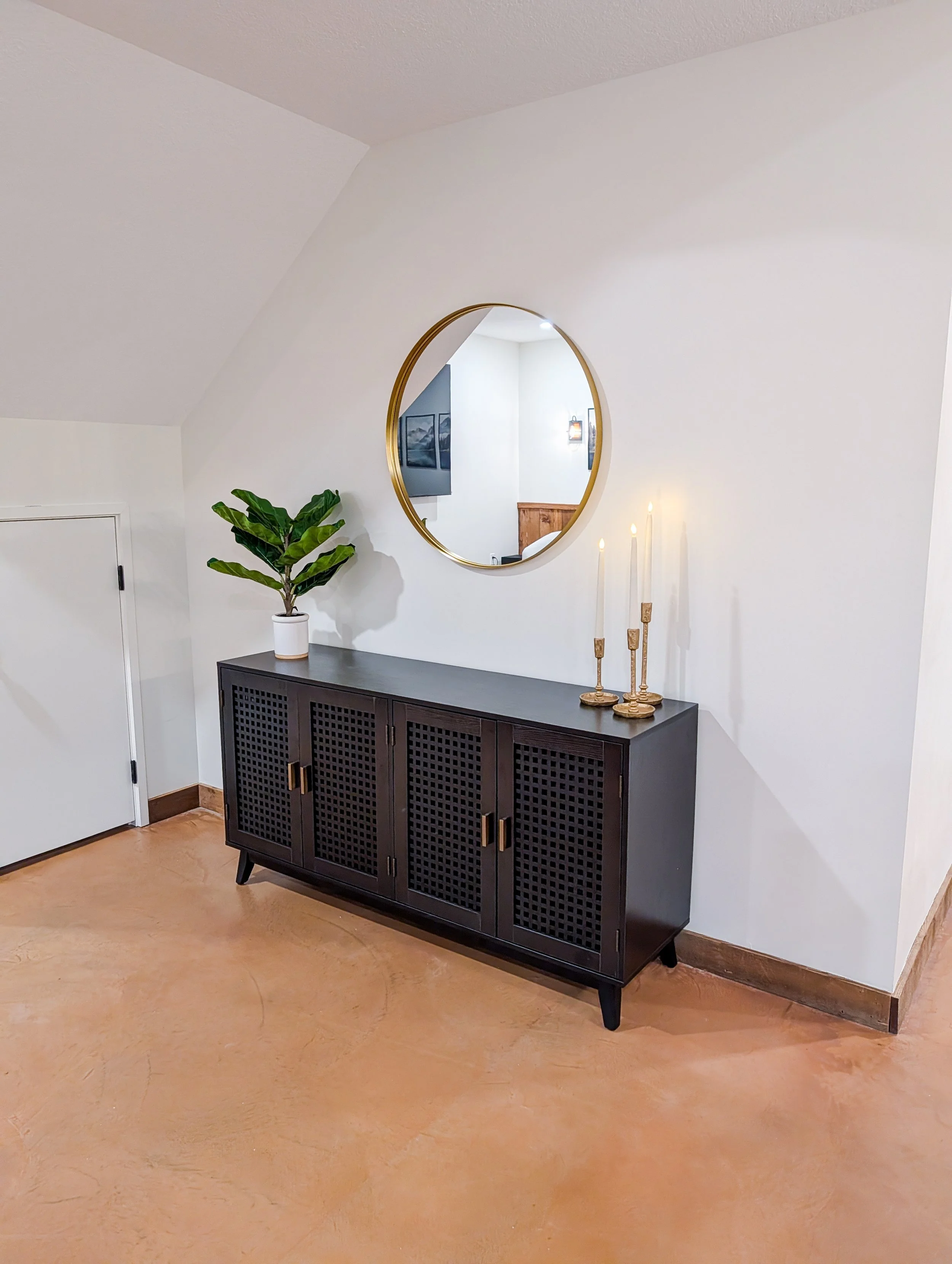 Copper-toned concrete overlay flooring in finished basement remodel in Grain Valley MO