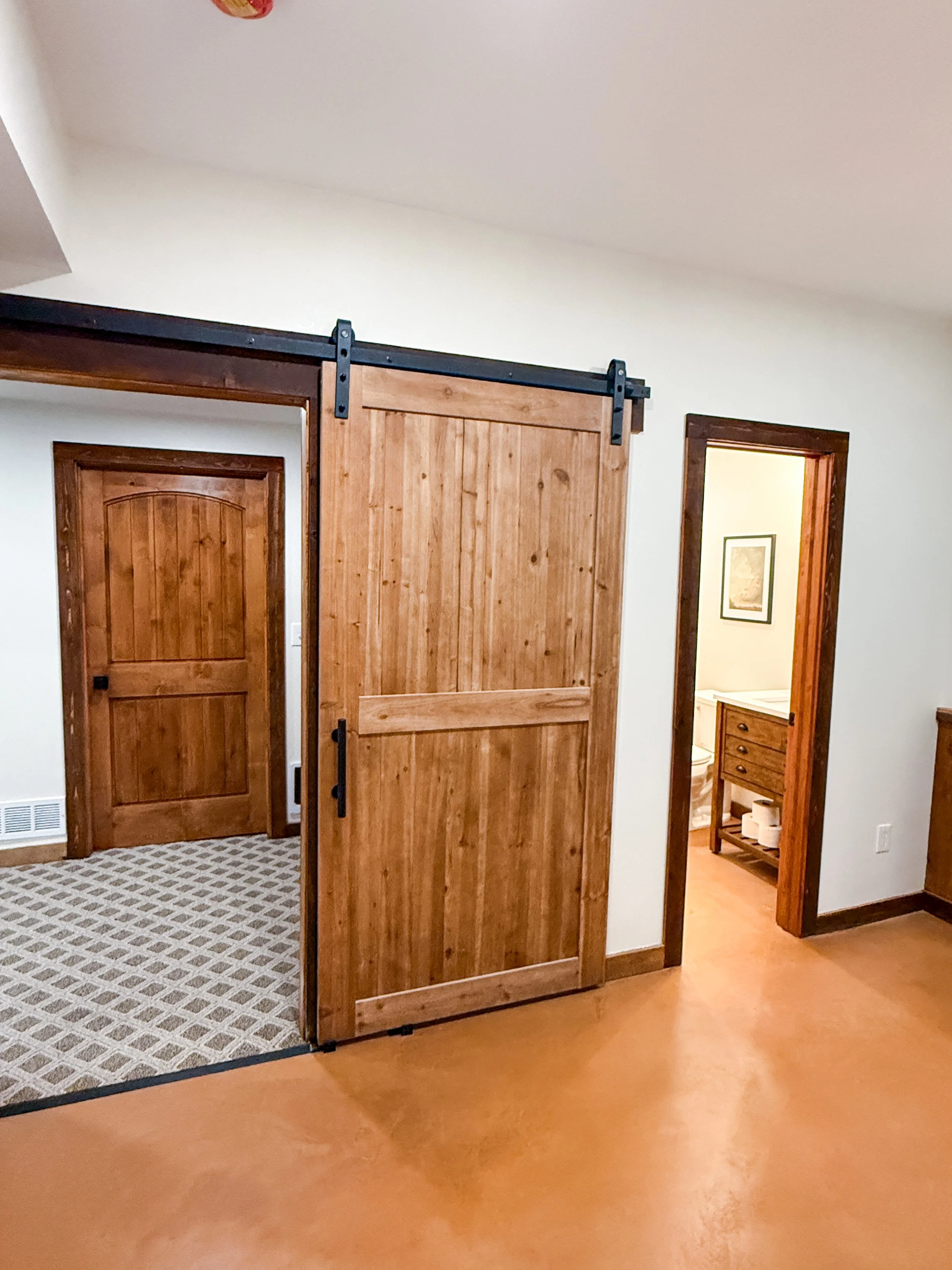 Cedar barn door for basement office in modern cabin home in Grain Valley Missouri
