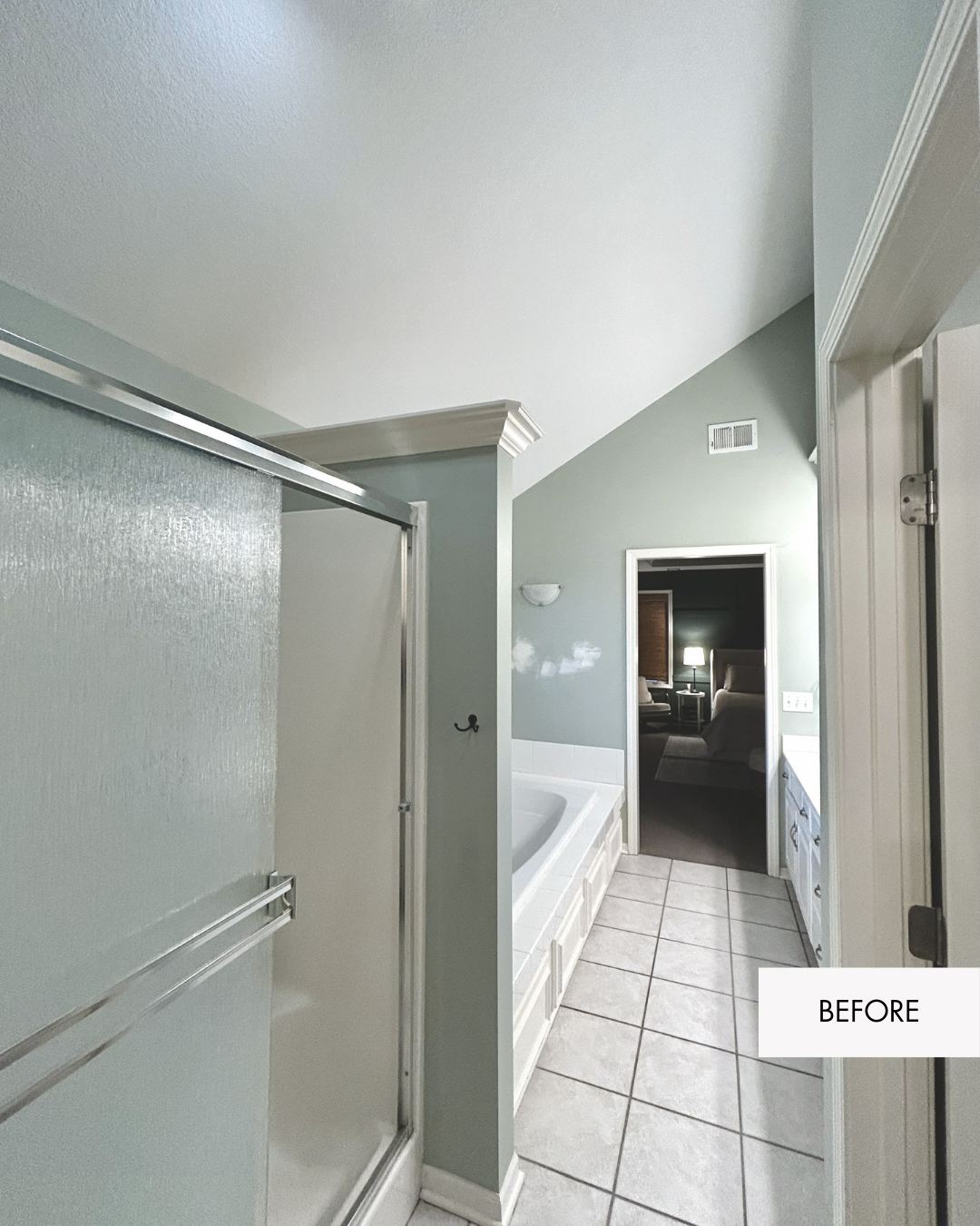 Before photo of old framed shower and old jetted tub in primary bathroom with dated floor tile