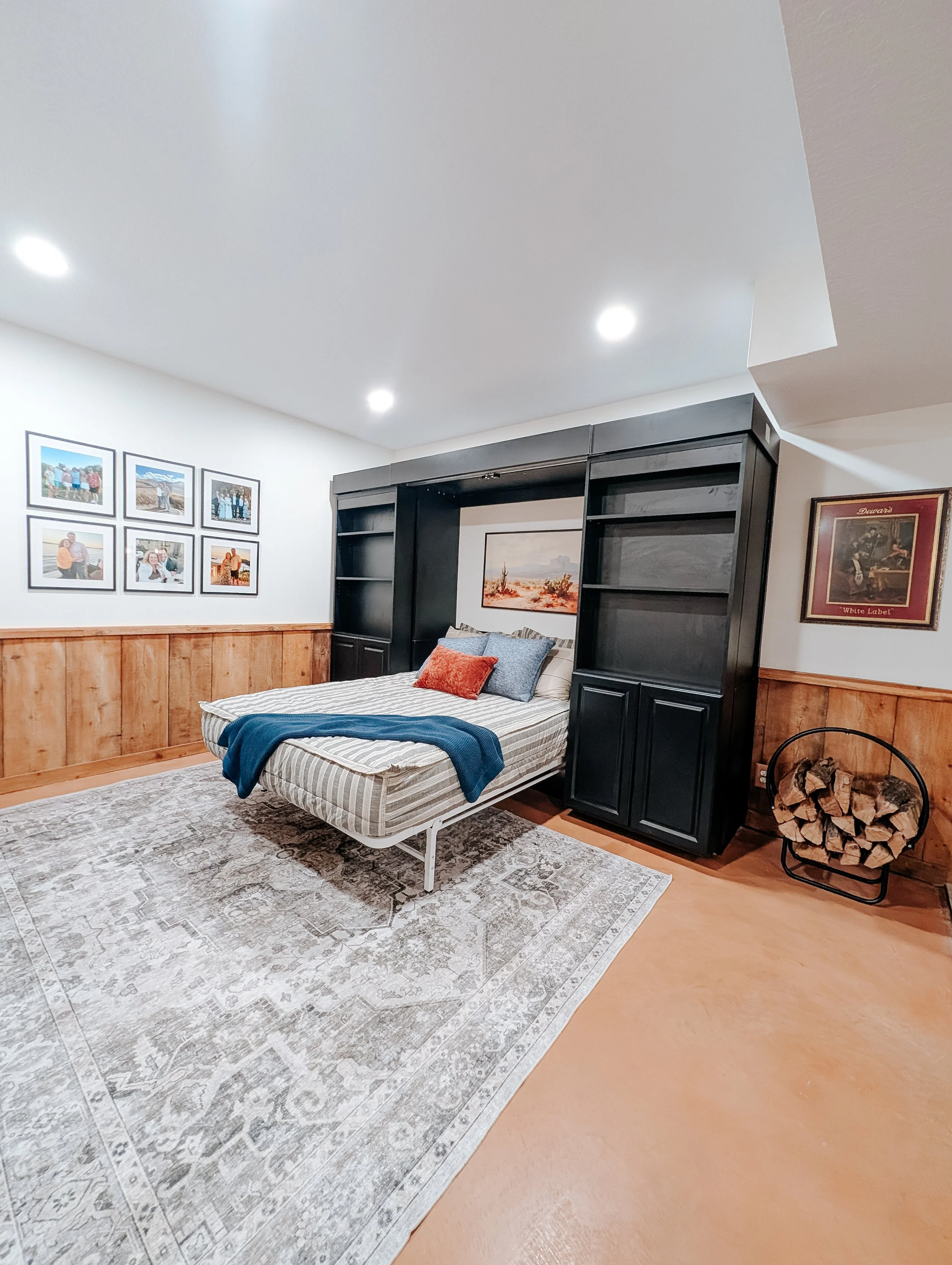 Basement guest bedroom with custom Murphy bed and built-in storage in Grain Valley Missouri