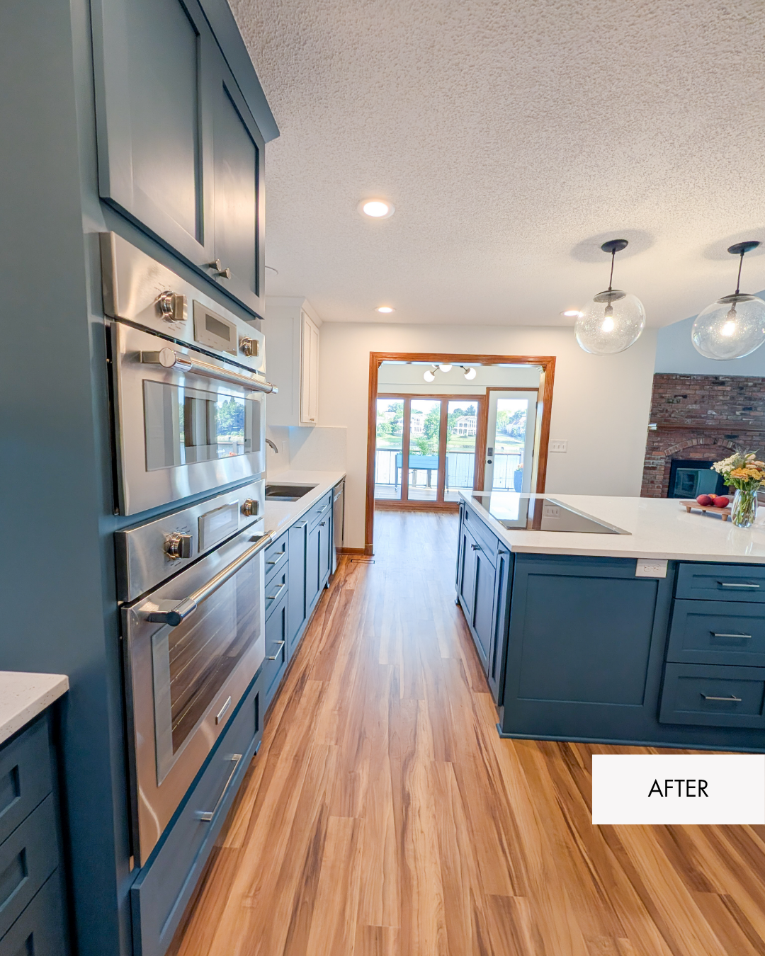 Remodeled Lee's Summit two toned kitchen with white walls, white upper cabinetry, blue lower cabinetry, MSI Sparkling White quartz countertops, new flooring and an open living room connection