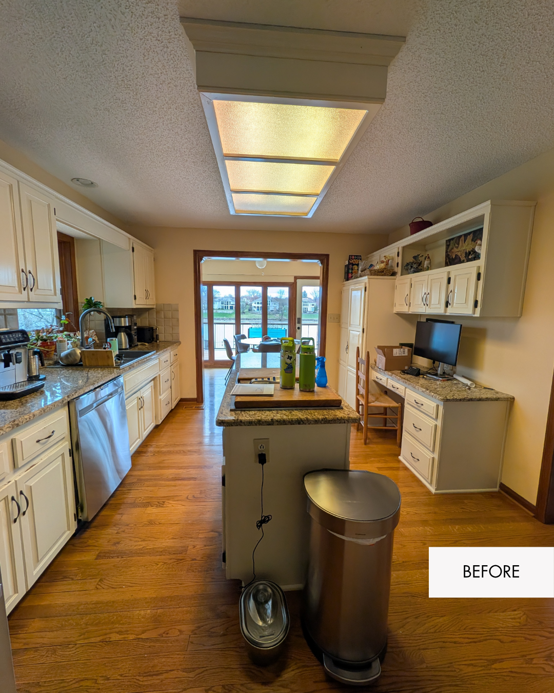 Lee's Summit kitchen before remodel with warm yellow paint and a closed-off layout separating it from the living room