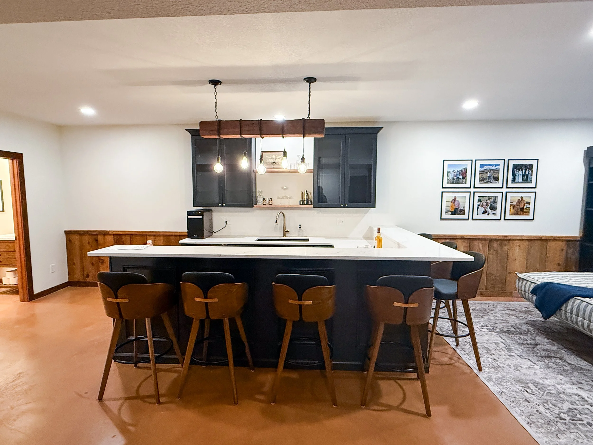 Custom black basement kitchenette bar with box trim in modern cabin remodel in Grain Valley Missouri
