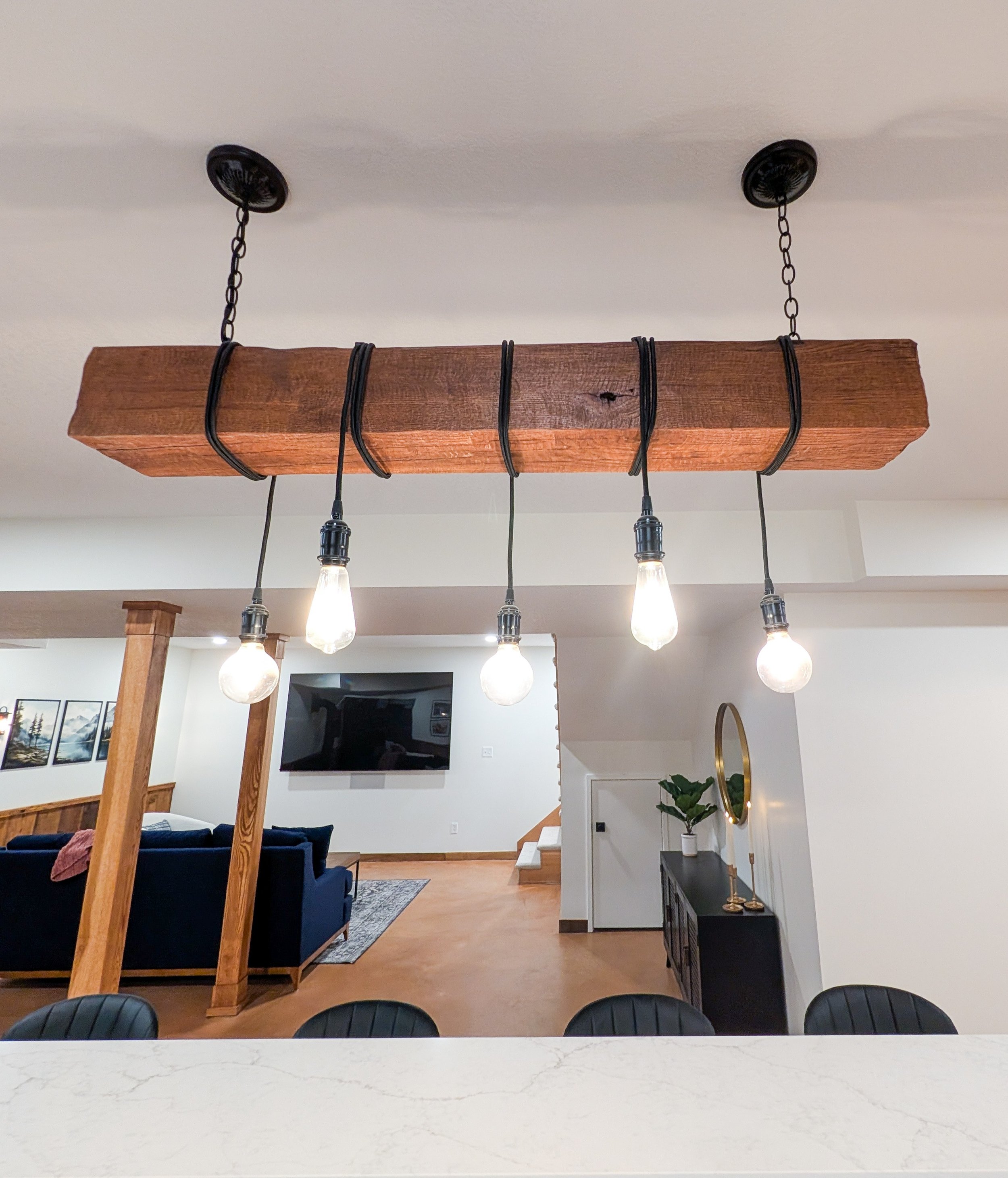 Custom reclaimed wood beam light fixture in basement remodel in Grain Valley MO
