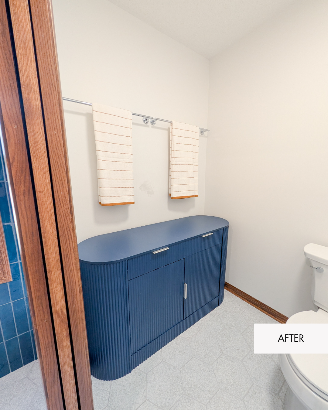 Private water closet after remodel with added storage and a pocket door in the former shower location
