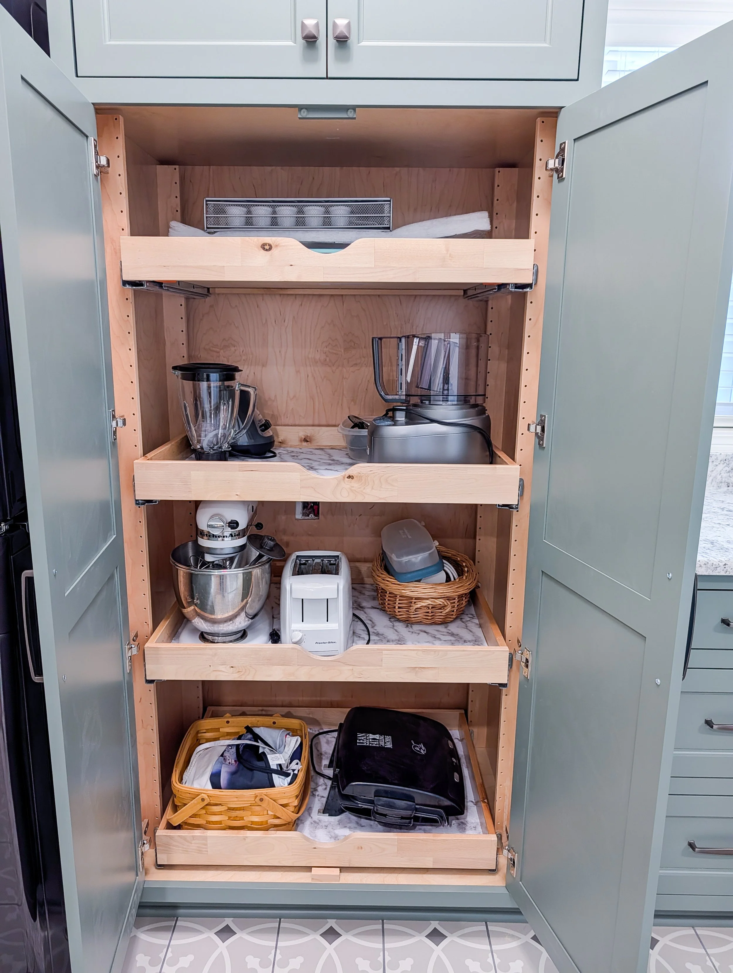 Close up of appliance garage in Lee's Summit Kitchen remodel with pullout shelves for the appliances to easily be stored and hidden away