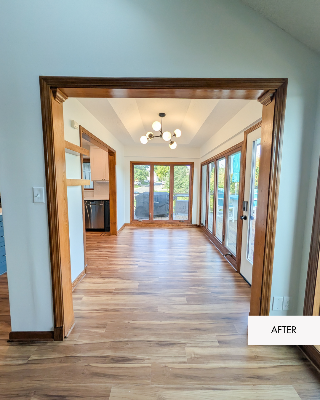 Refreshed lakehouse sunroom with new paint, updated lighting and finishes that coordinate with the adjoining kitchen