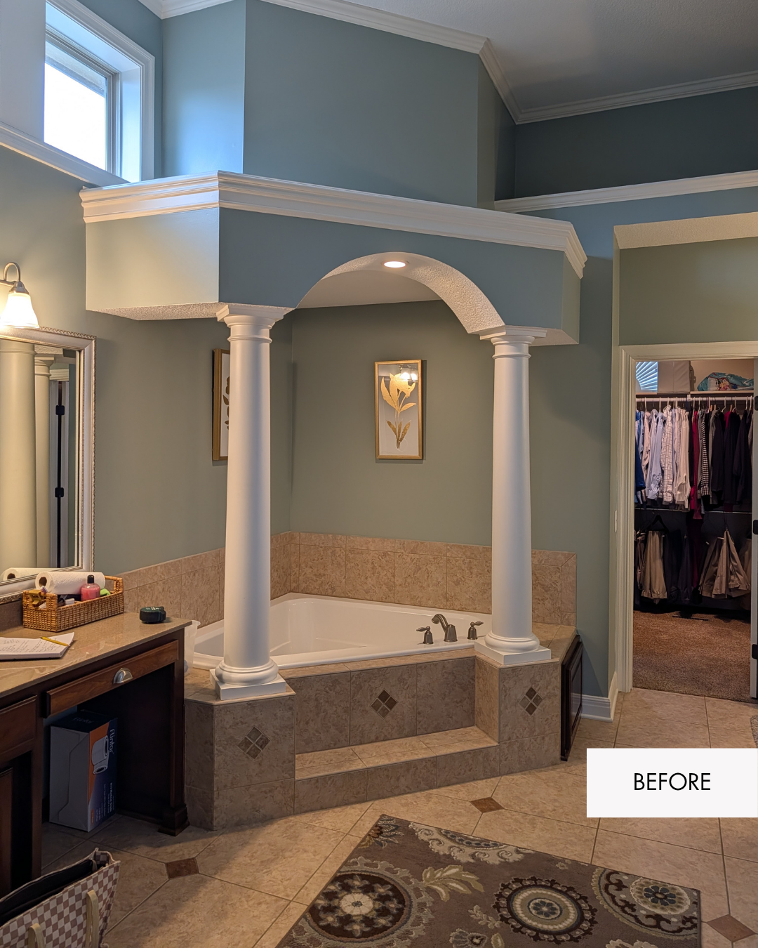 Before photo of oversized jetted tub with tiled deck, columns and overhead arch