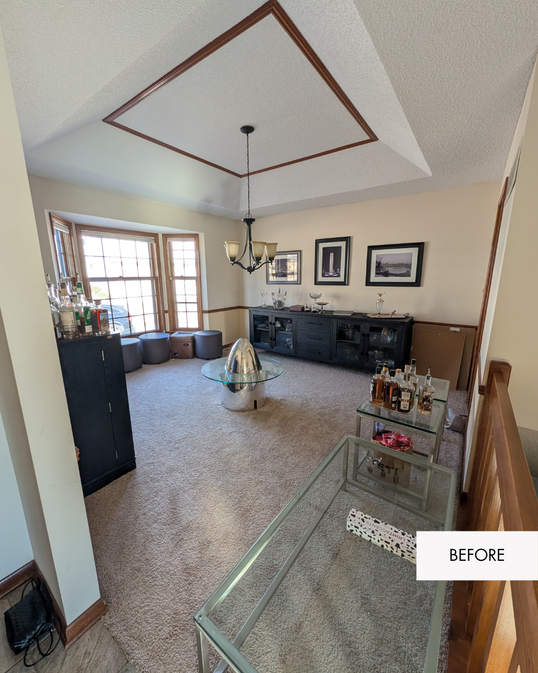 Before photo of a Lee's Summit entryway with a dated 80's handrail, dated light fixture and old carpet