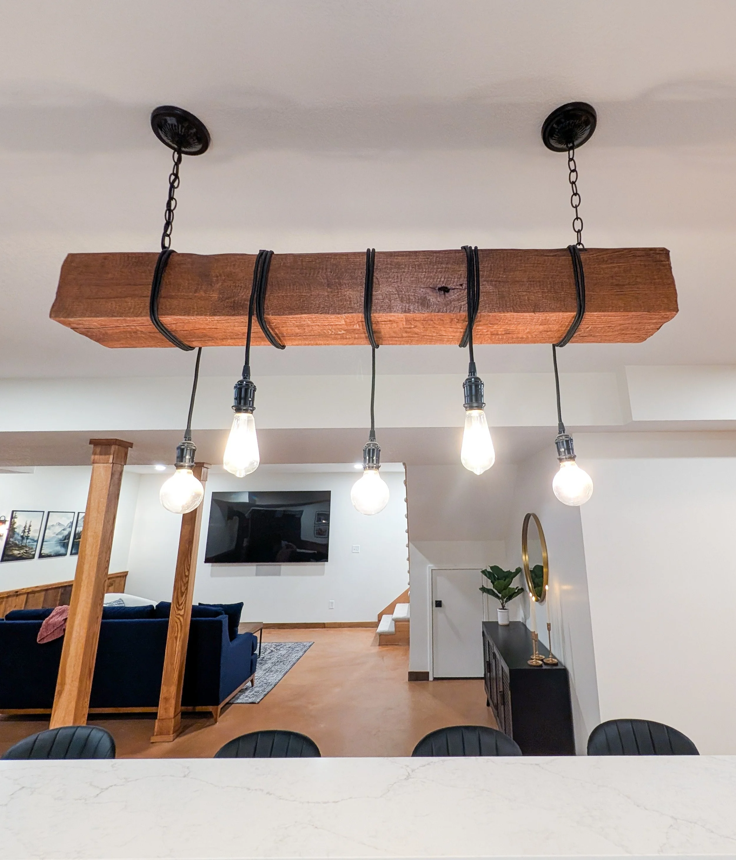 Custom reclaimed wood beam light fixture in basement remodel in Grain Valley MO