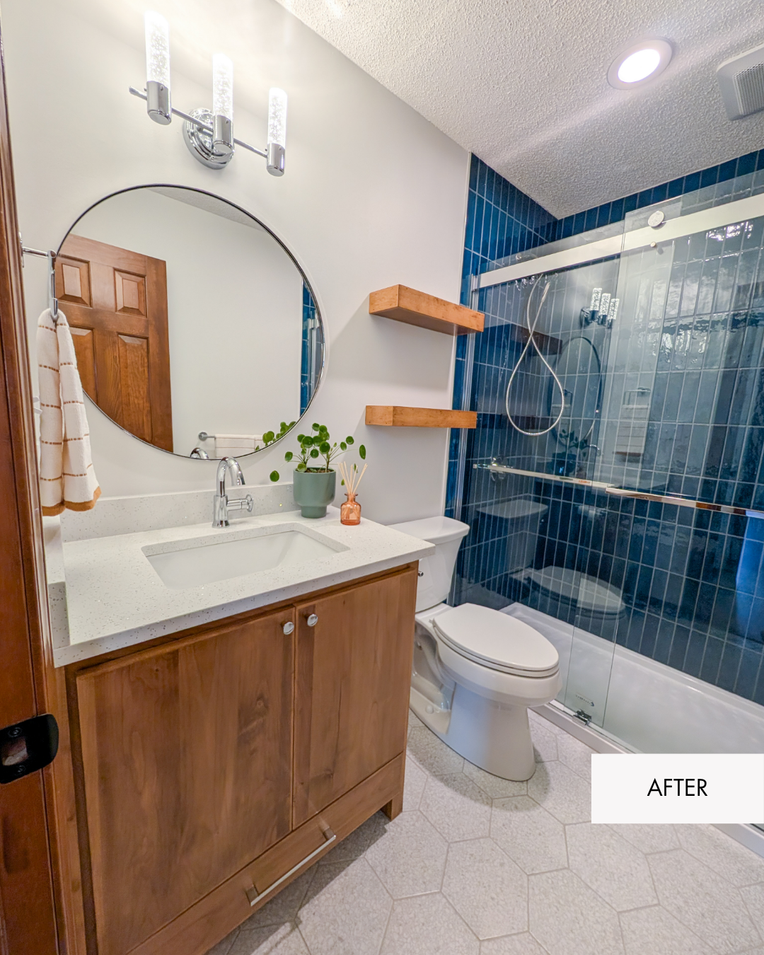Remodeled hall bathroom with modern wood vanity, blue Daltile shower tile, updated fixtures and a cheerful lake house-inspired design