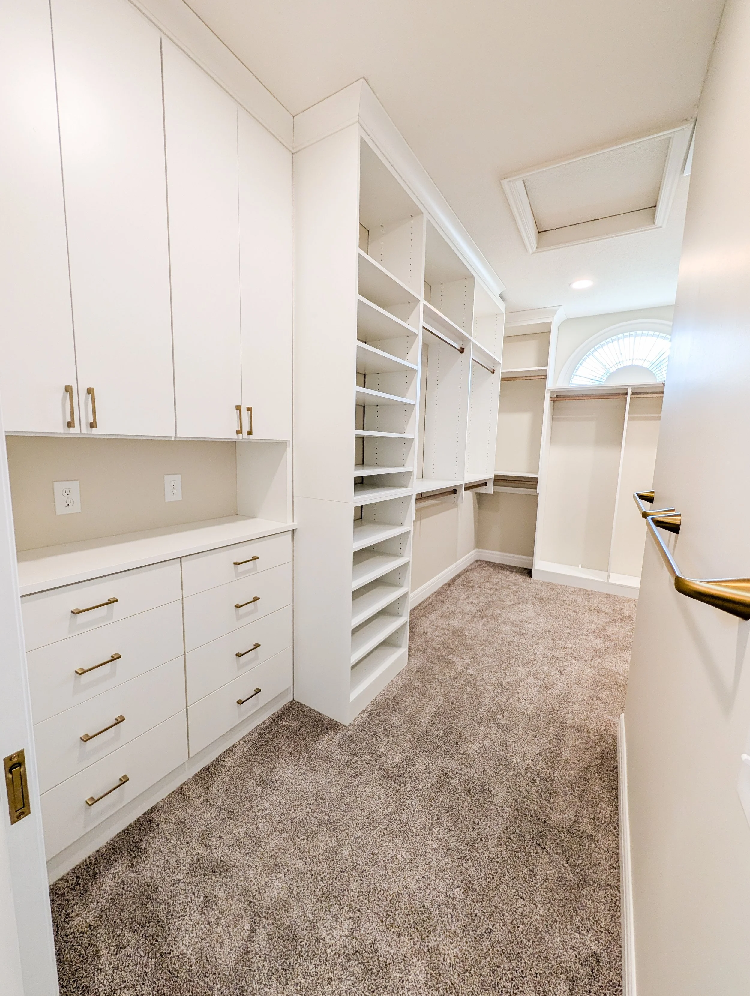 Lee's Summit primary bedroom closet remodel with white closet cabinets and gold hardware