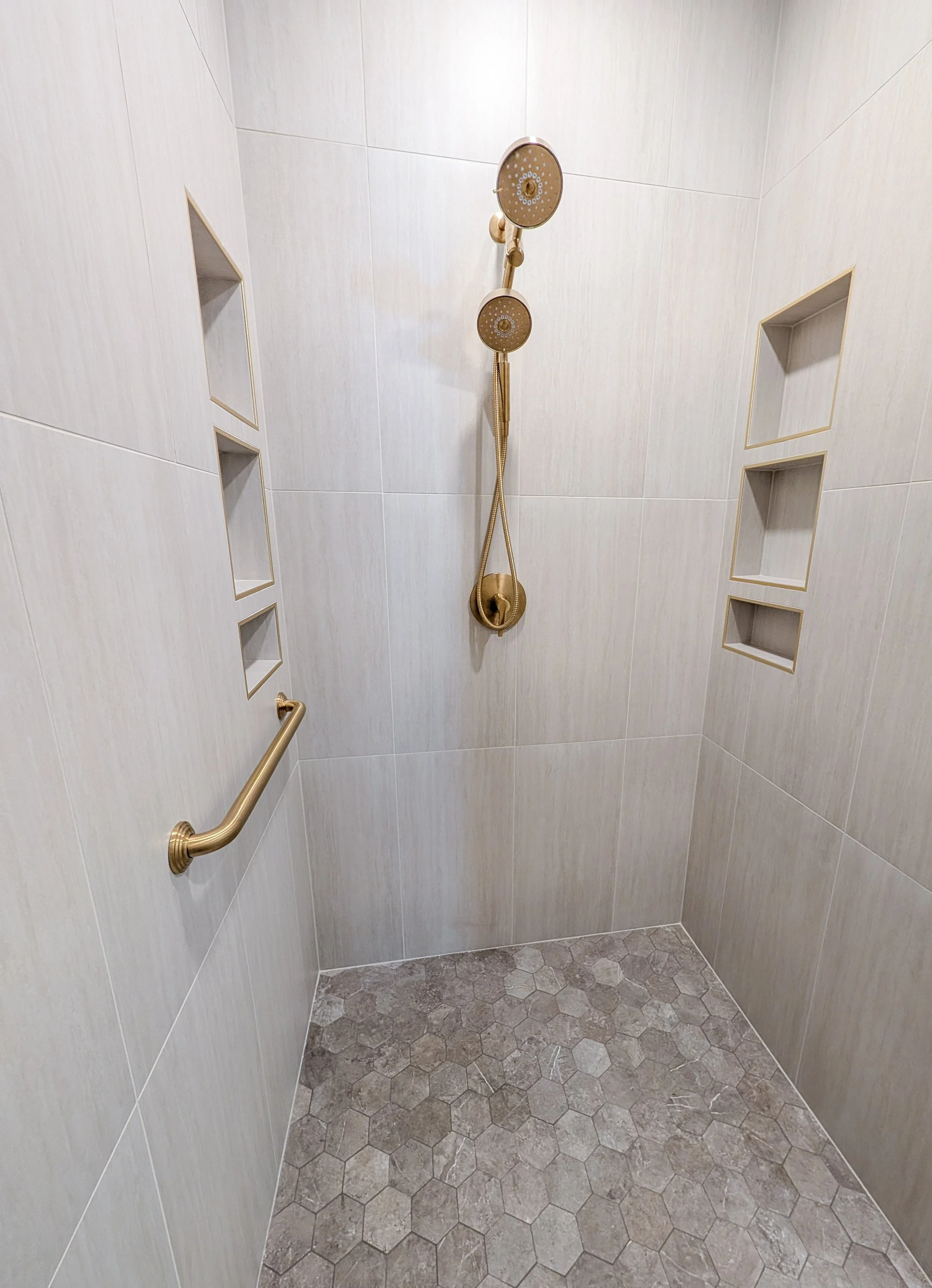 Lee's Summit bathroom remodel with walk in shower, gold accents, grab bar, shower niches and hexagon flor tile