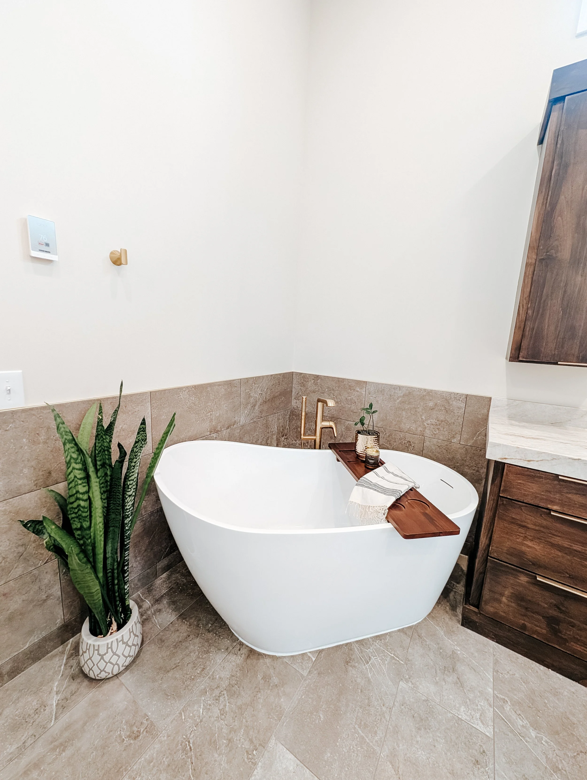 Lee's Summit bathroom remodel with freestanding tub and gold finishes