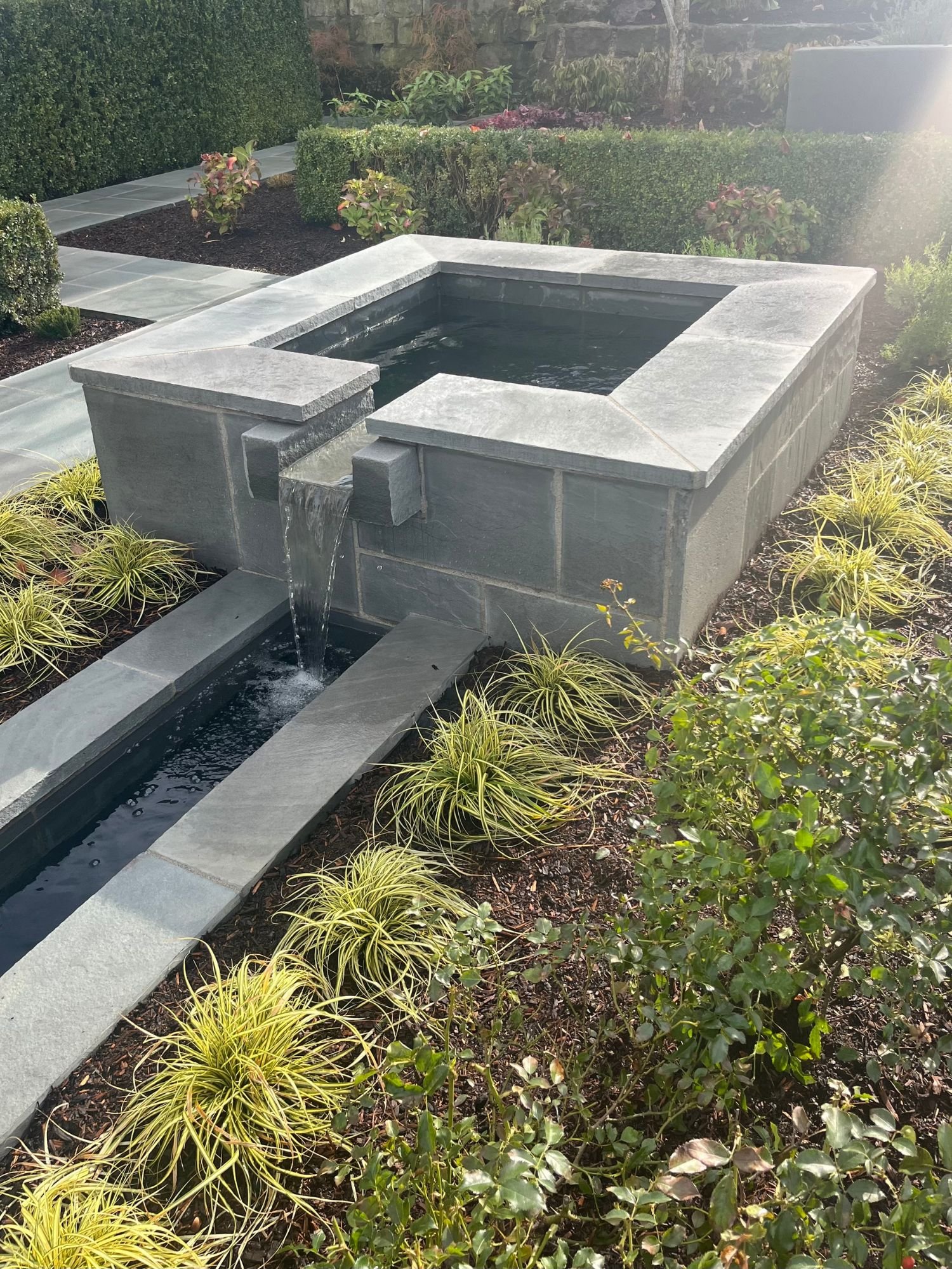 A beautiful, square fountain installed in the backyard of a luxury home in Lake Oswego, OR. 