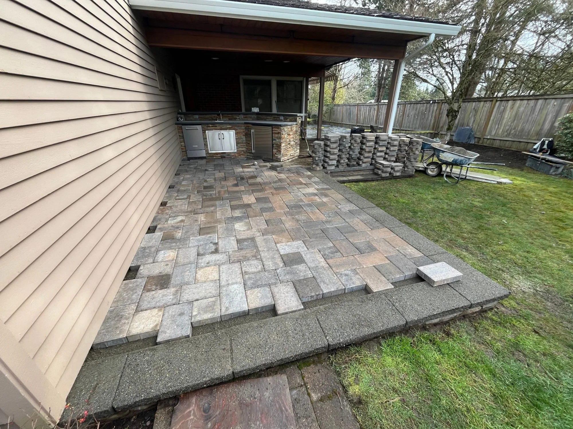 A new stone patio in a residential backyard in West Linn, Oregon. 