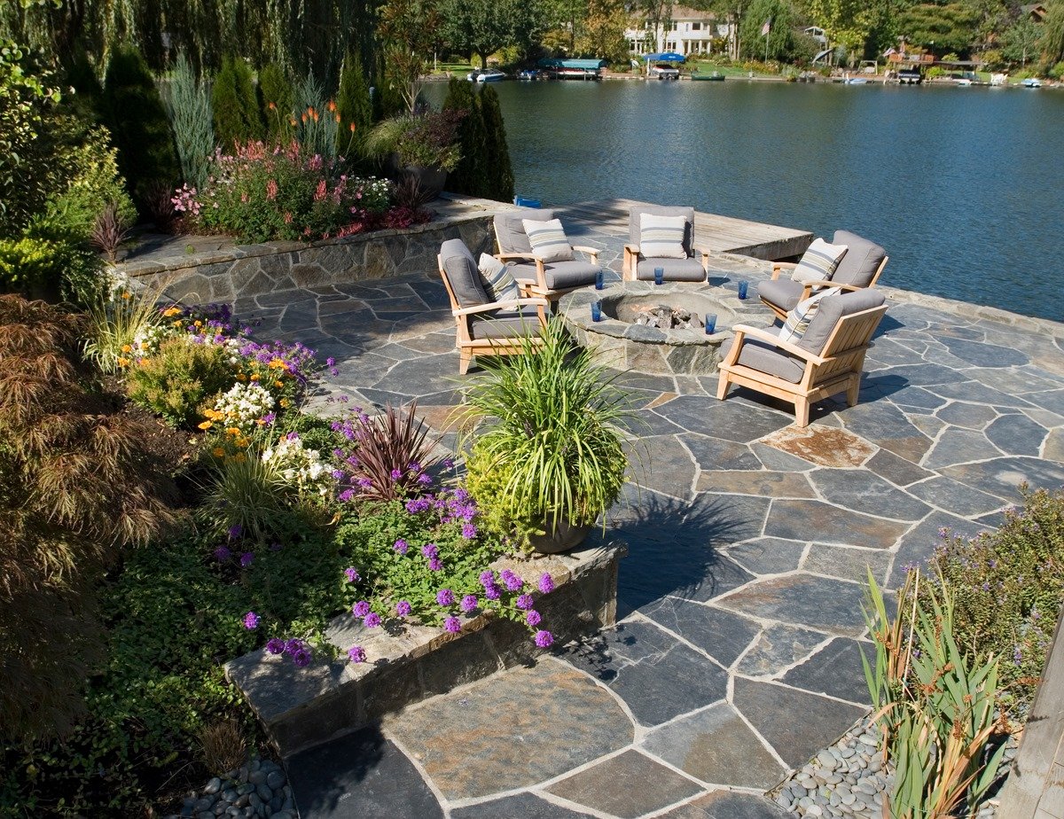 A picturesque landscaped patio in front of a lovely lake in Happy Valley, OR. 