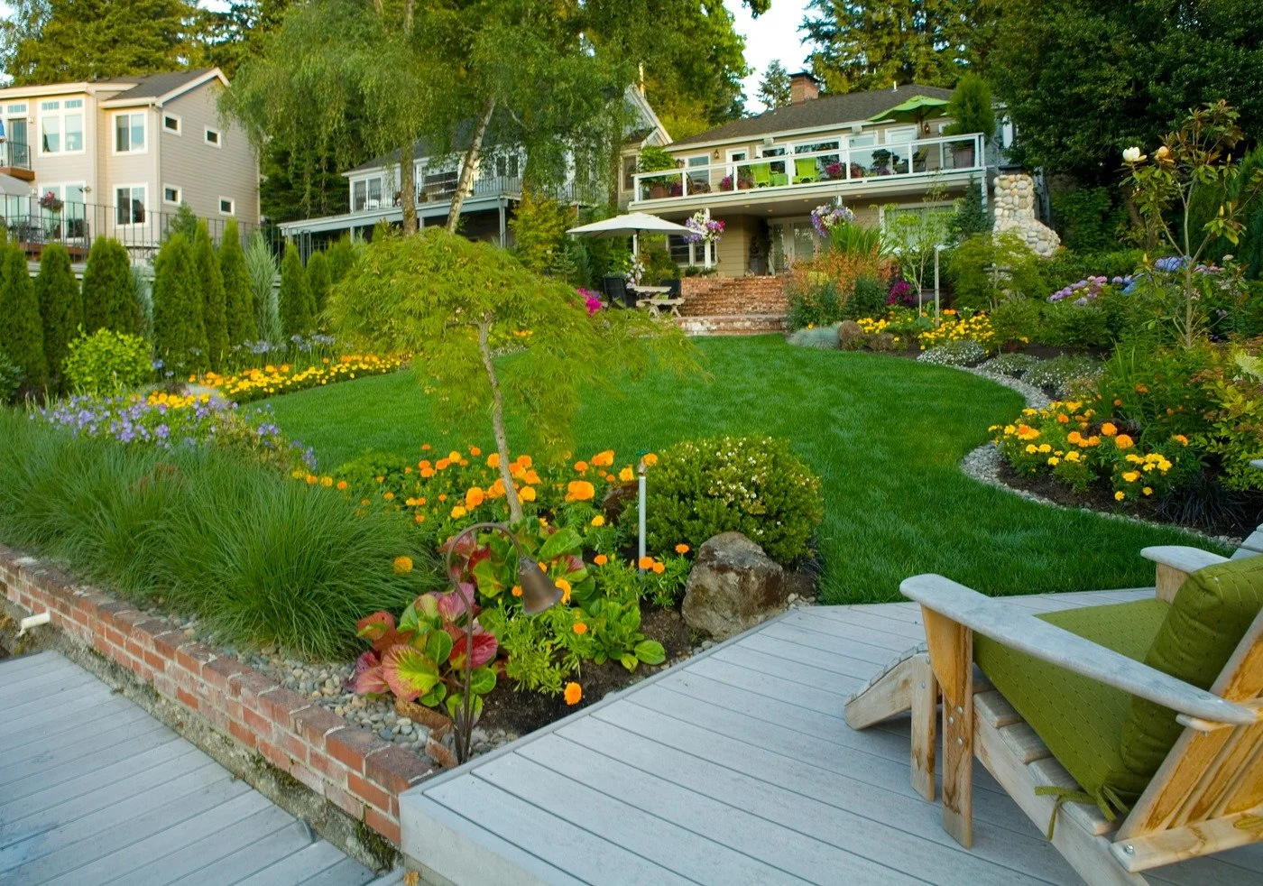 A large, open green lawn and elegant flagstone patio offer a stunning view of a Hillsboro home, perfect for outdoor living.