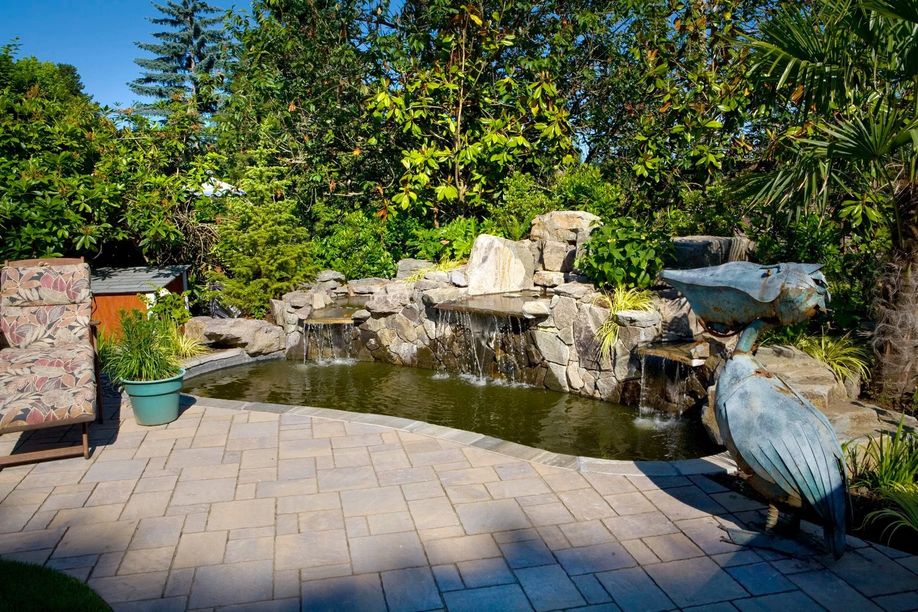 A waterfall and landscape installation completed by a landscaping company in Happy Valley. 
