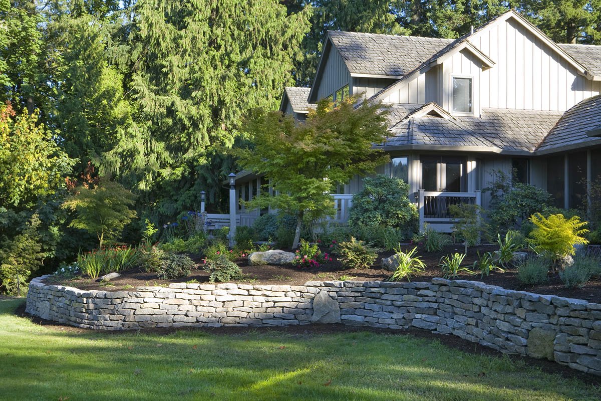 A picture of a residential Portland backyard with a neat yardscape filled with local plants and built by Big Sky Landscaping