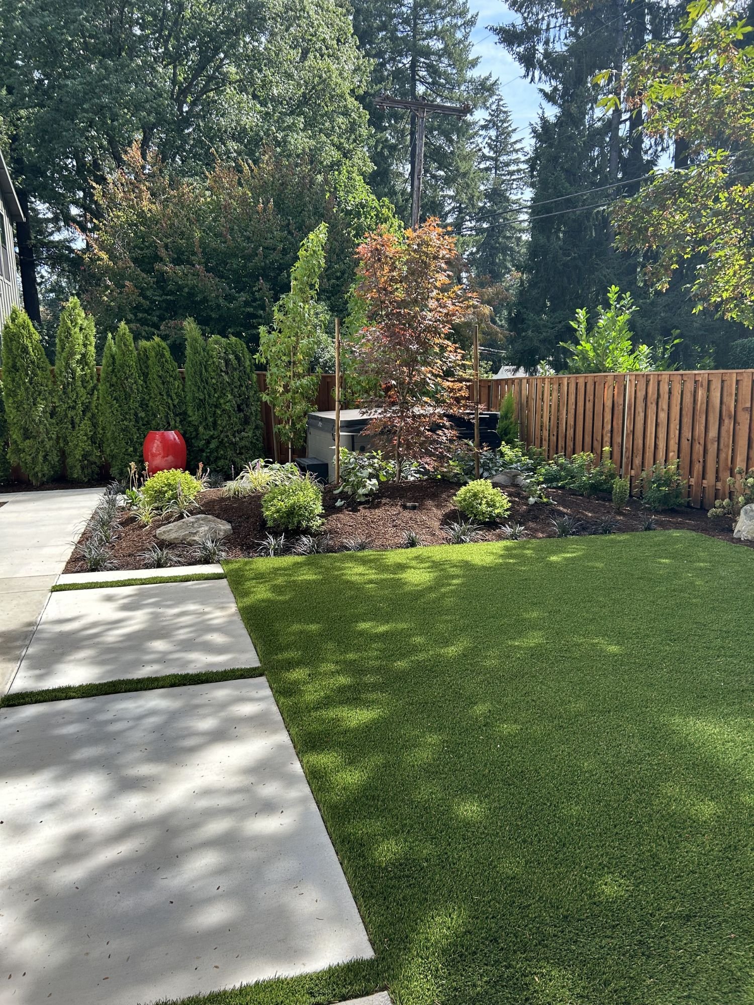 A perfectly manicured backyard with fresh landscaping installed and maintained by Big Sky Landscaping. 