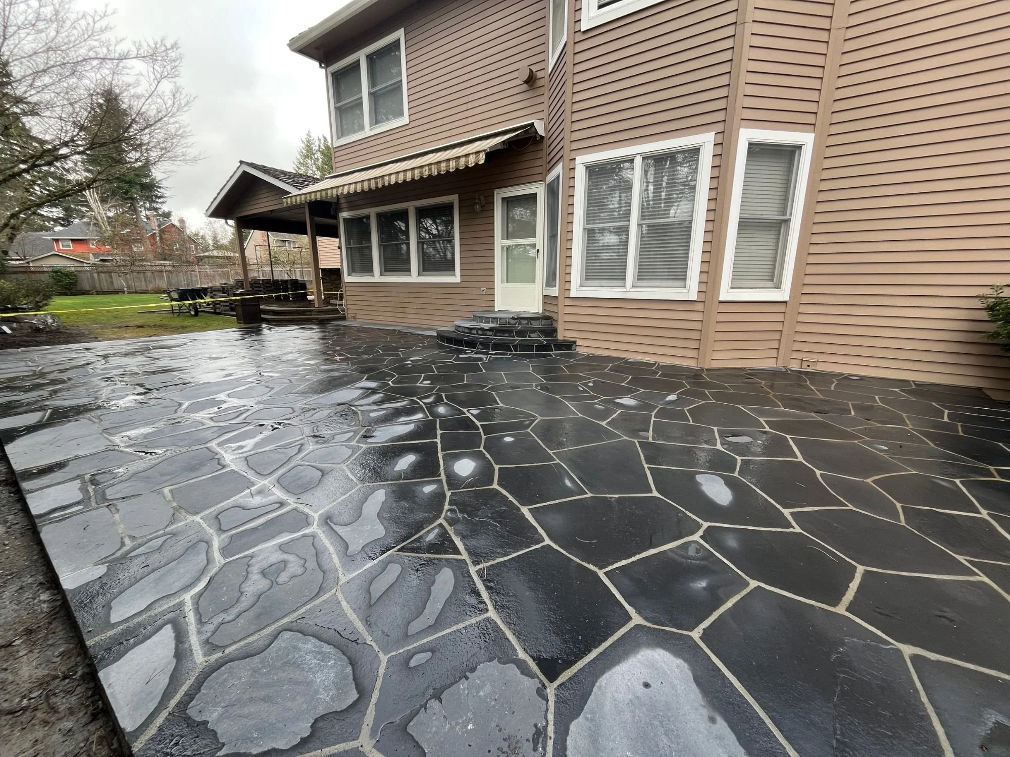 A beautiful black stone patio paved by Big Sky Landscaping during a project in West Linn, Oregon.