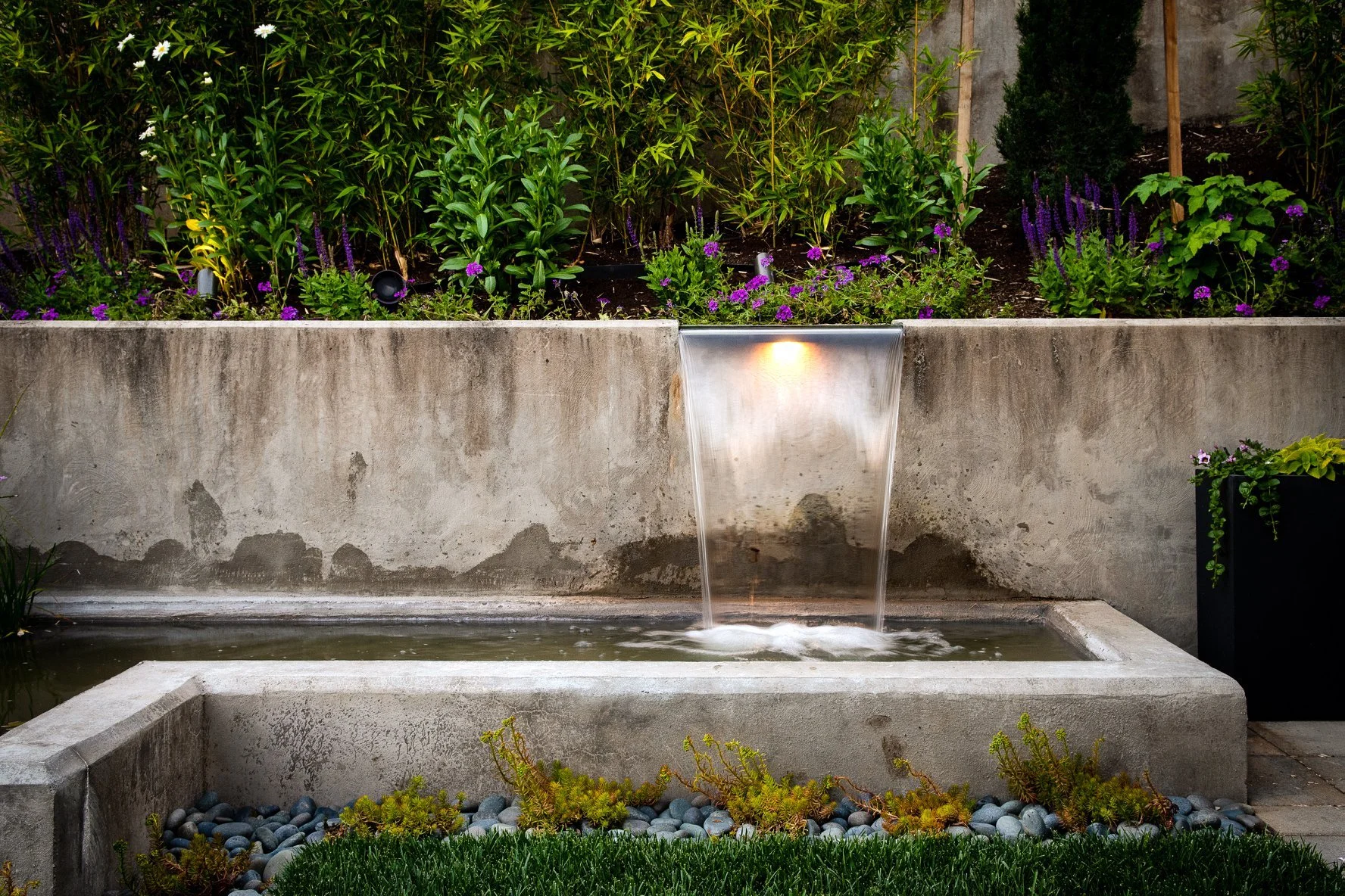 Professional Hillsboro landscapers are responsible for designing this stunning multi-tiered rock waterfall.
