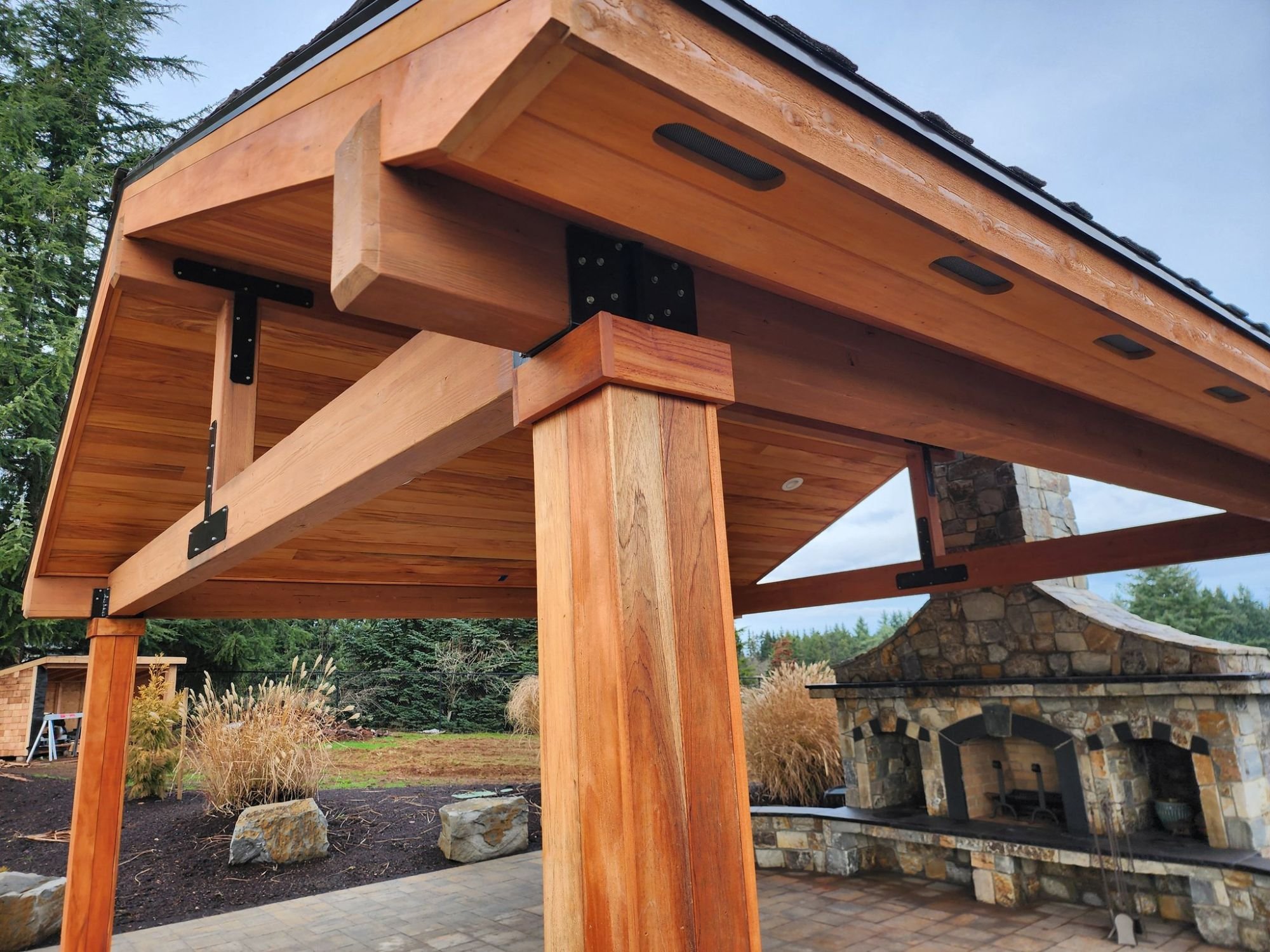 A wooden gazebo featured in a recently constructed landscape design project for a residential home in Lake Oswego. 