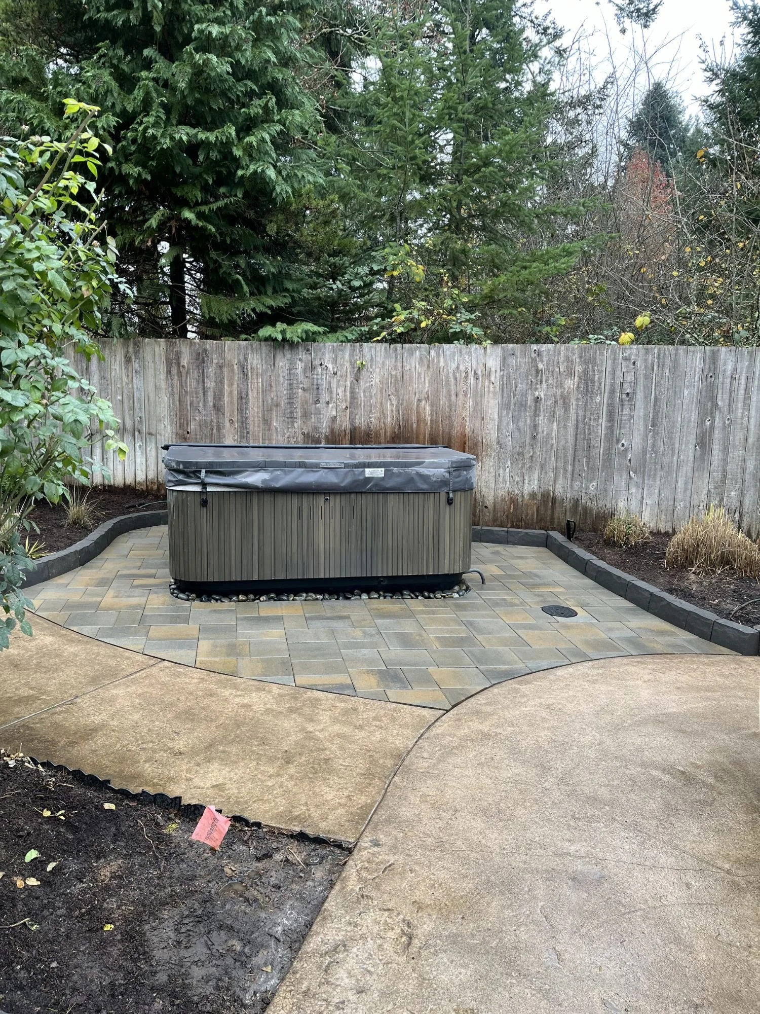 A hot tub sitting ontop of a patio recently installed by Big Sky Landscaping, a patio installation company in West Linn.