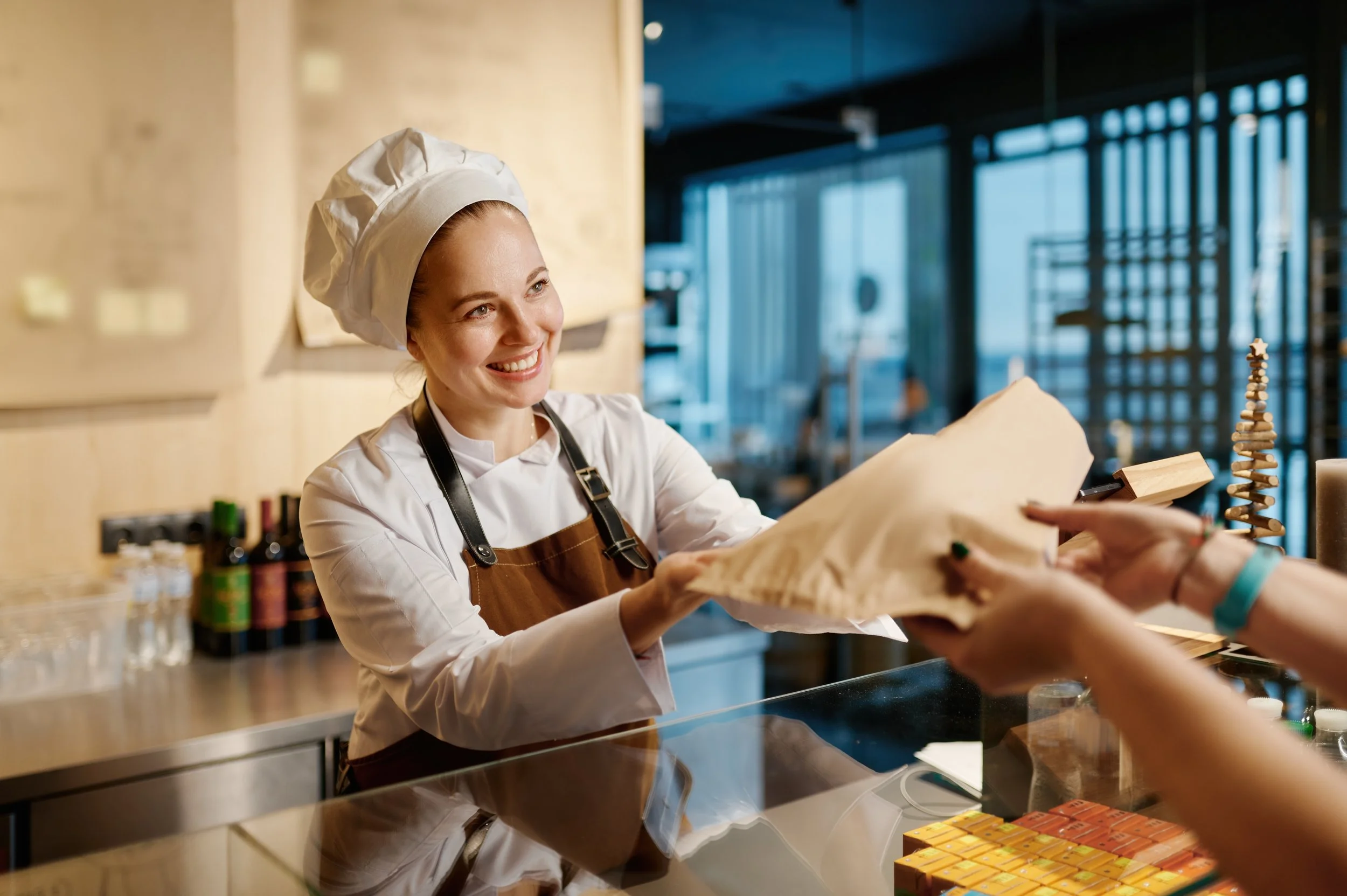 bakery-worker-selling-fresh-tasty-pastry-and-bread-2023-03-31-17-24-45-utc.jpg